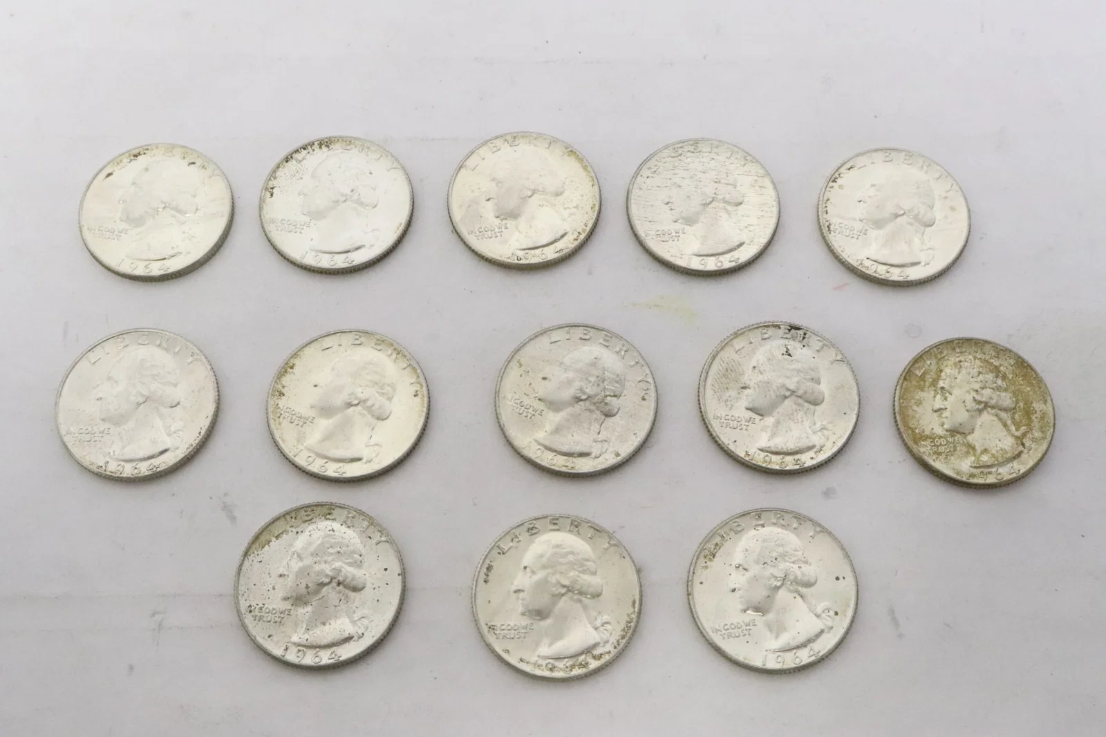 13 uncirculated 1964 US silver quarters