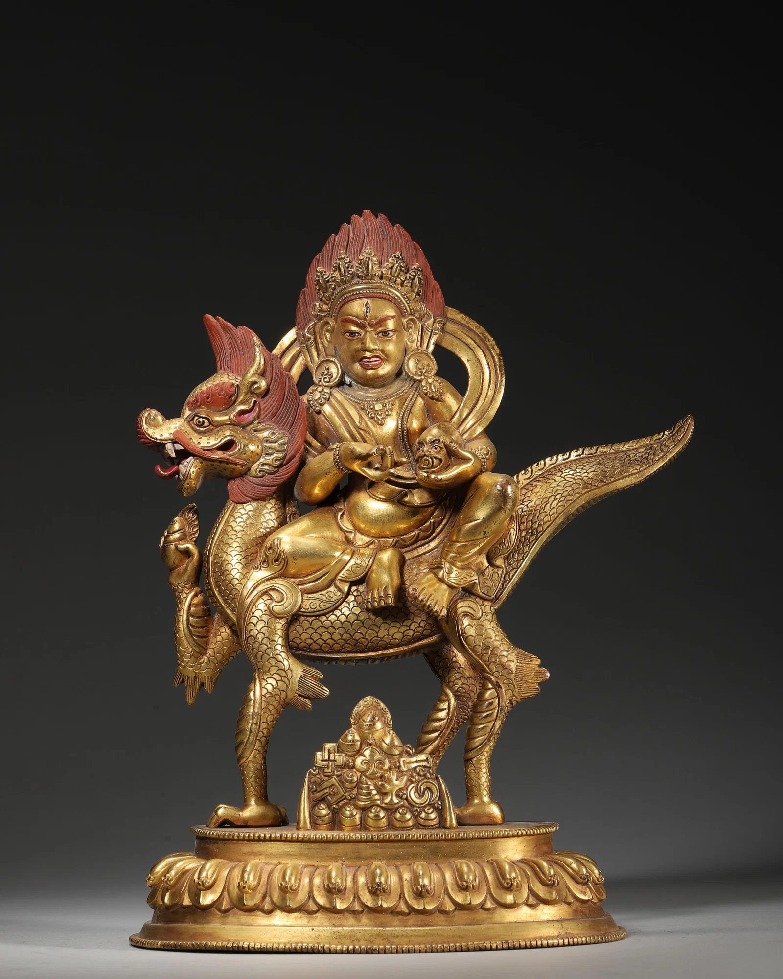 18TH–19TH CENTURY GILT-COPPER STATUE OF WHITE JAMBHALA RIDING A DRAGON