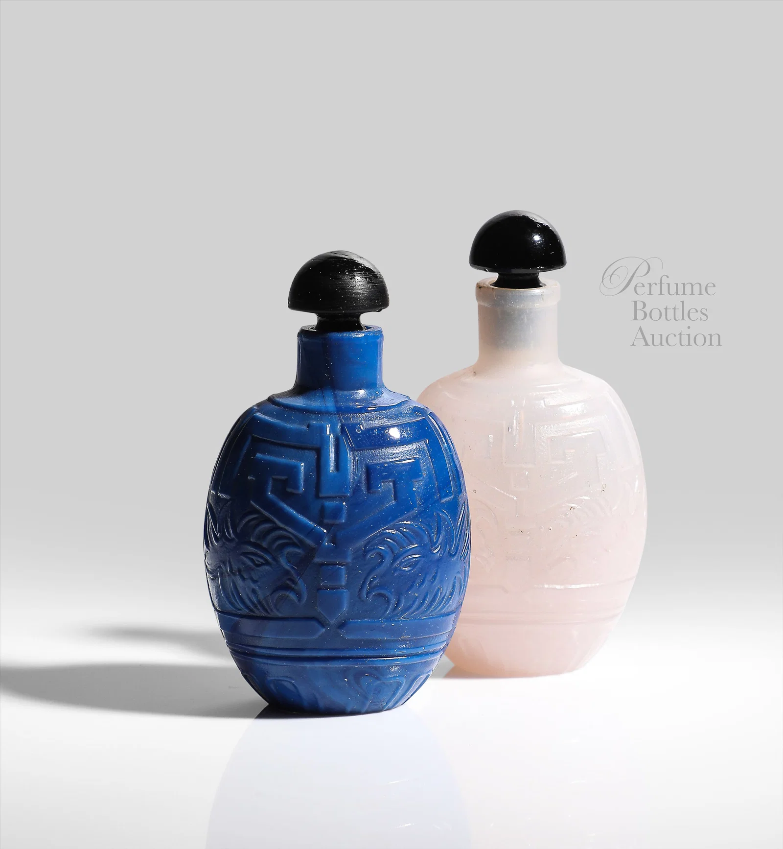 1925 Two perfume bottles for Miga, Chinese scent bottle form, white opaline glass and lapis glass