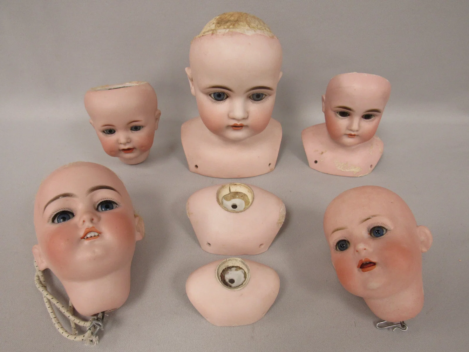 (5) BISQUE DOLL HEADS & (2) SHOULDER PLATES:
