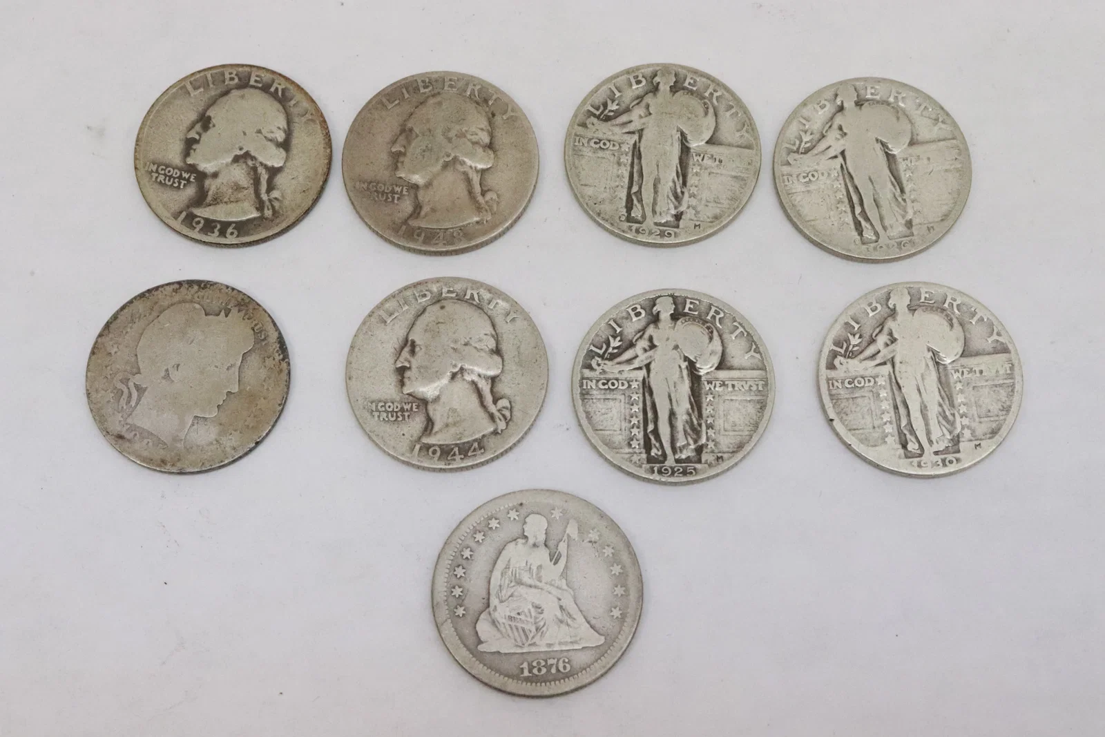 9 US silver quarters, various dates