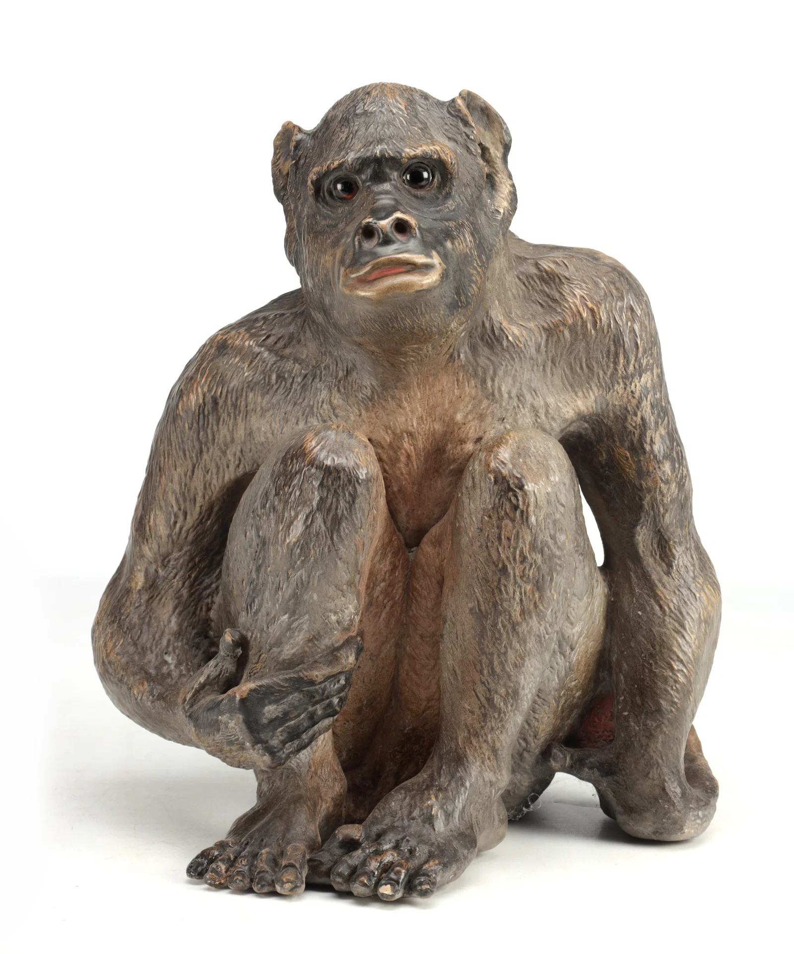 A 19TH CENTURY AUSTRIAN TERRACOTTA SCULPTURE OF A SEATED MONKEY