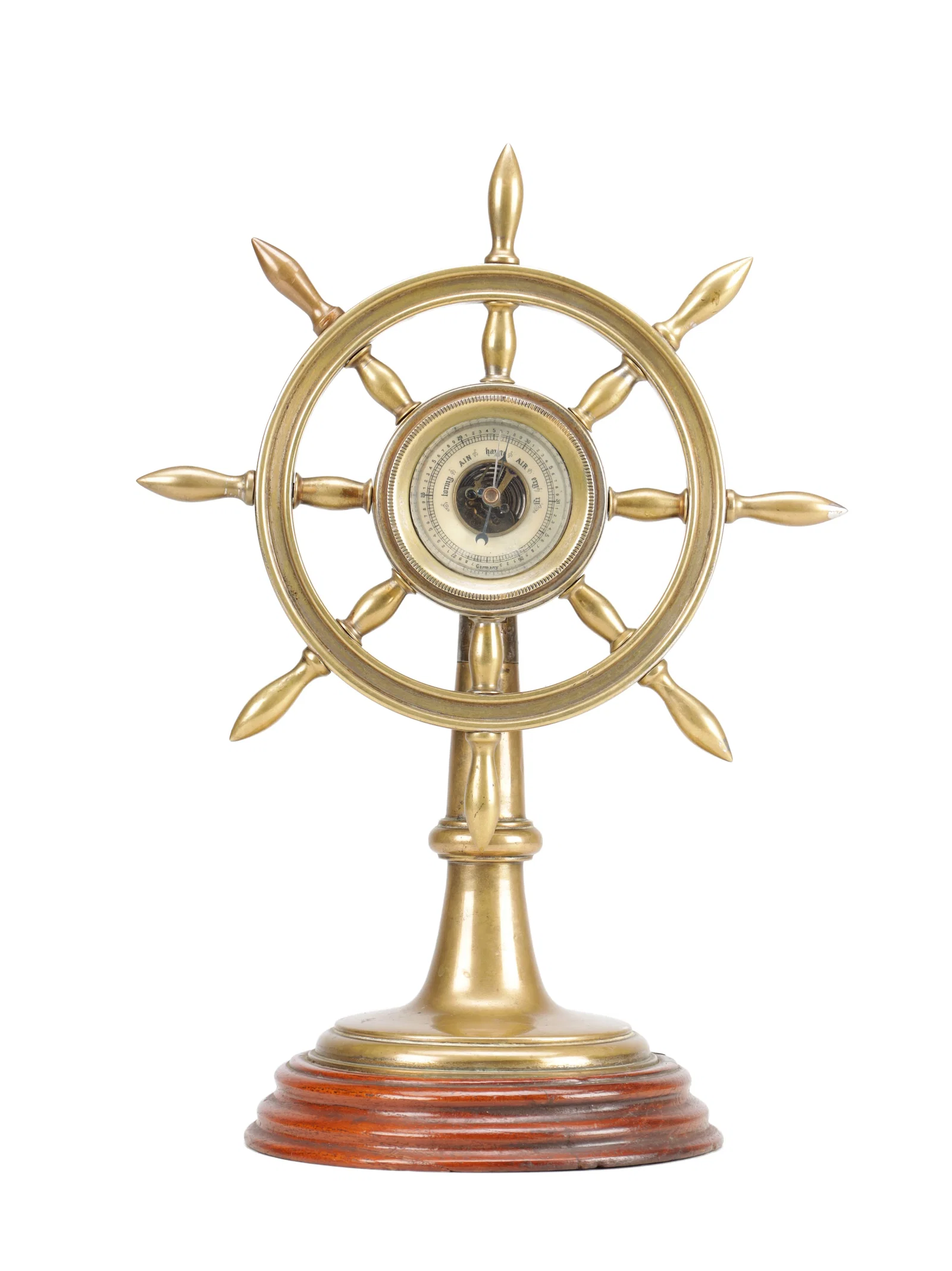 A 19TH CENTURY BRASS SHIP'S WHEEL ANEROID DESK BAROMETER ON TURNED MAHOGANY BASE