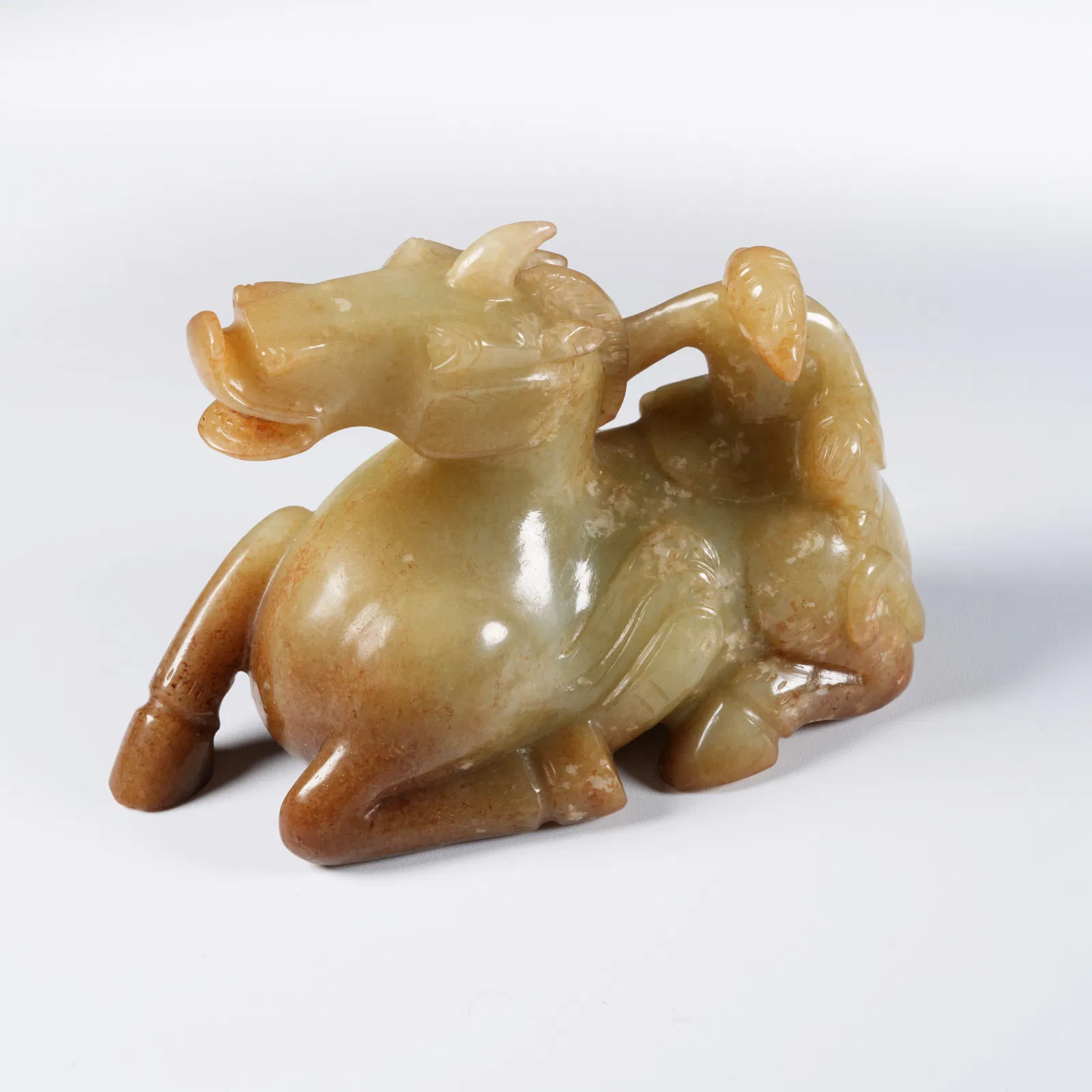 A ANCIENT JADE "BARBARIAN TAMING BEAST" ORNAMENT
