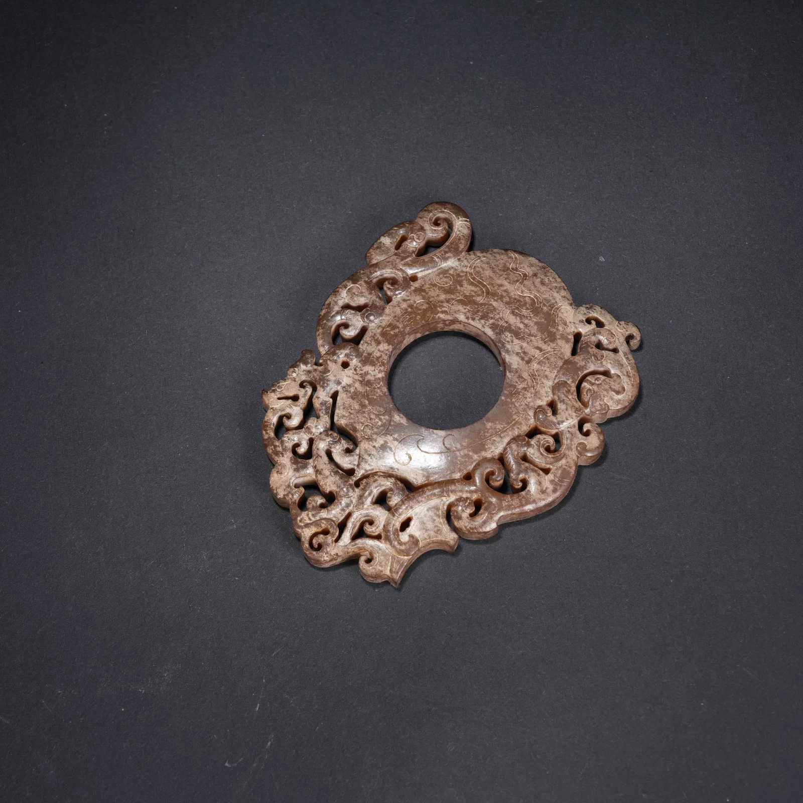 A ANCIENT JADE CHICKEN-HEART PENDANT WITH CHI DRAGON MOTIF
