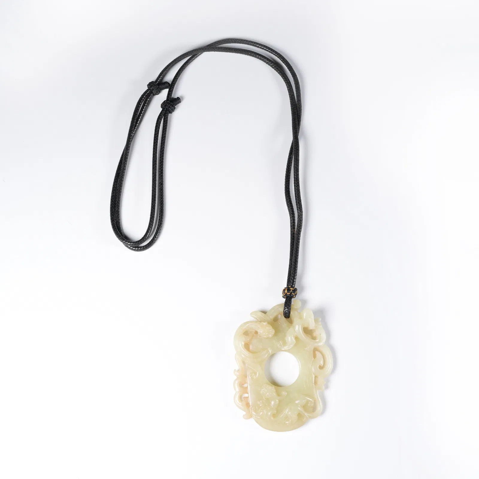 A ANCIENT JADE CHICKEN-HEART PENDANT WITH DRAGON MOTIF