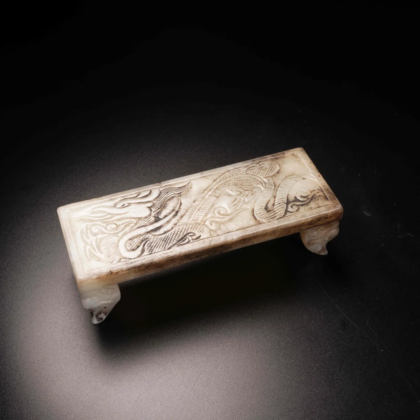 A ANCIENT JADE INK REST WITH CLOUD-AND-DRAGON MOTIF