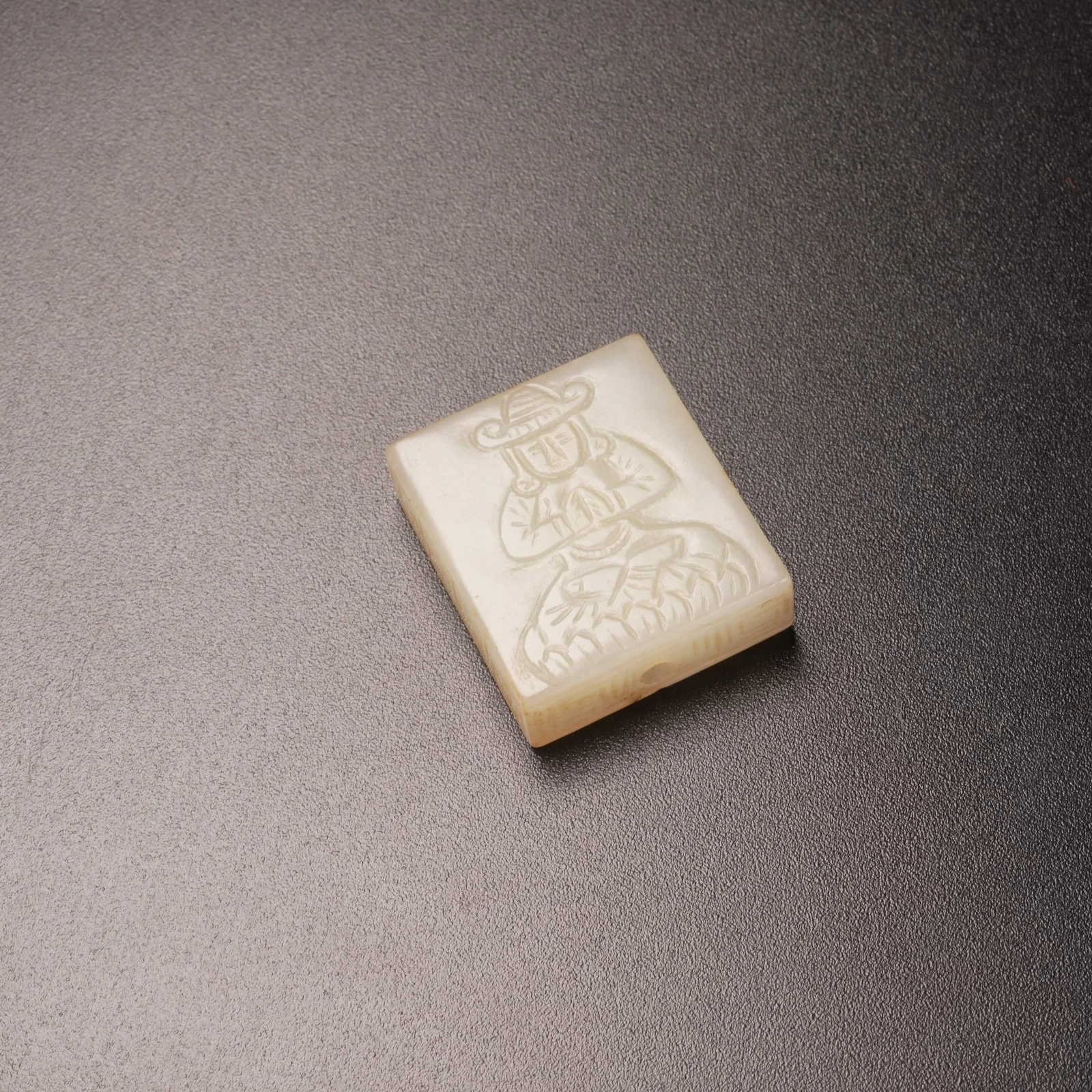 A ANCIENT JADE PENDANT WITH BARBARIAN FIGURE MOTIF