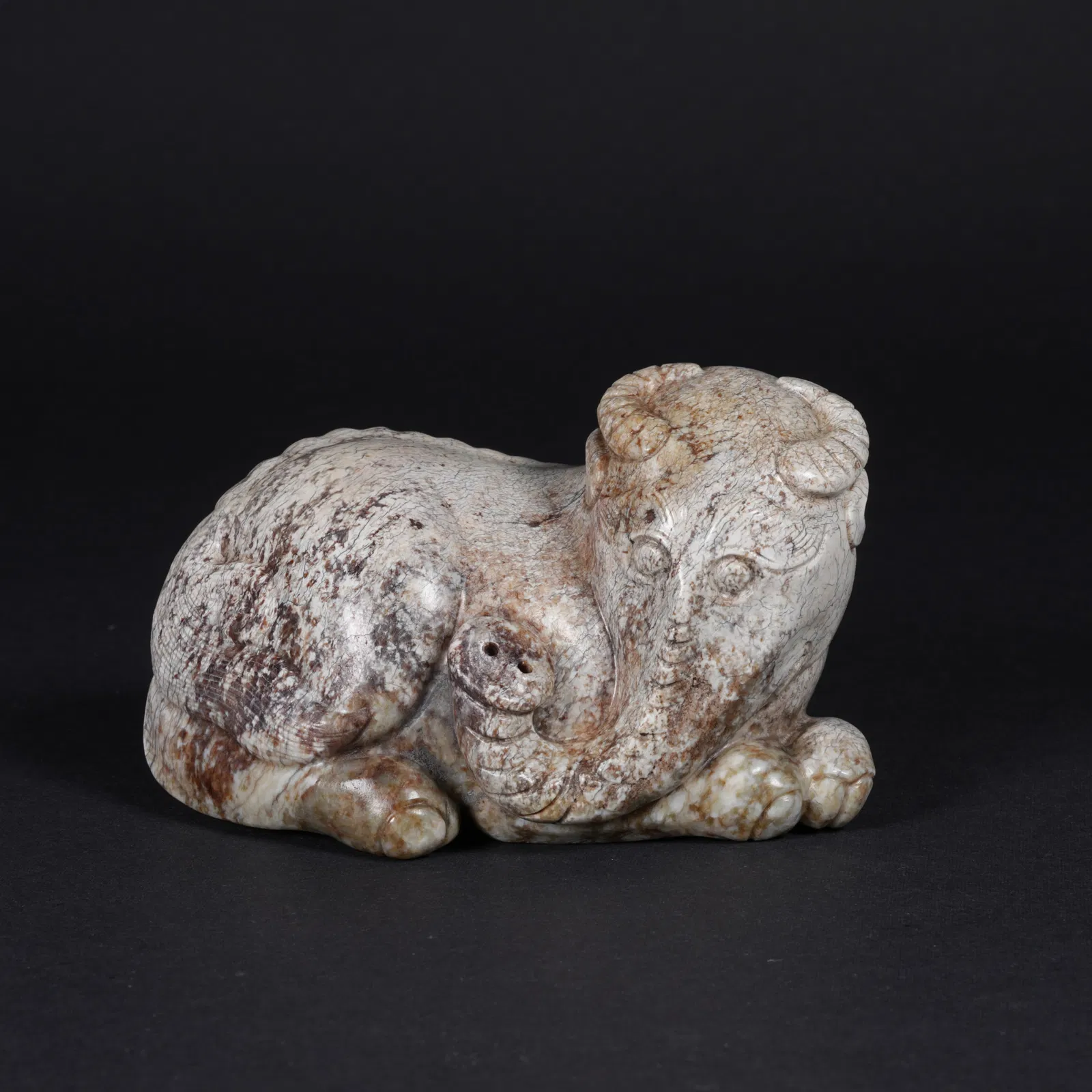 A ARCHAIC JADE AUSPICIOUS BEAST FIGURINE