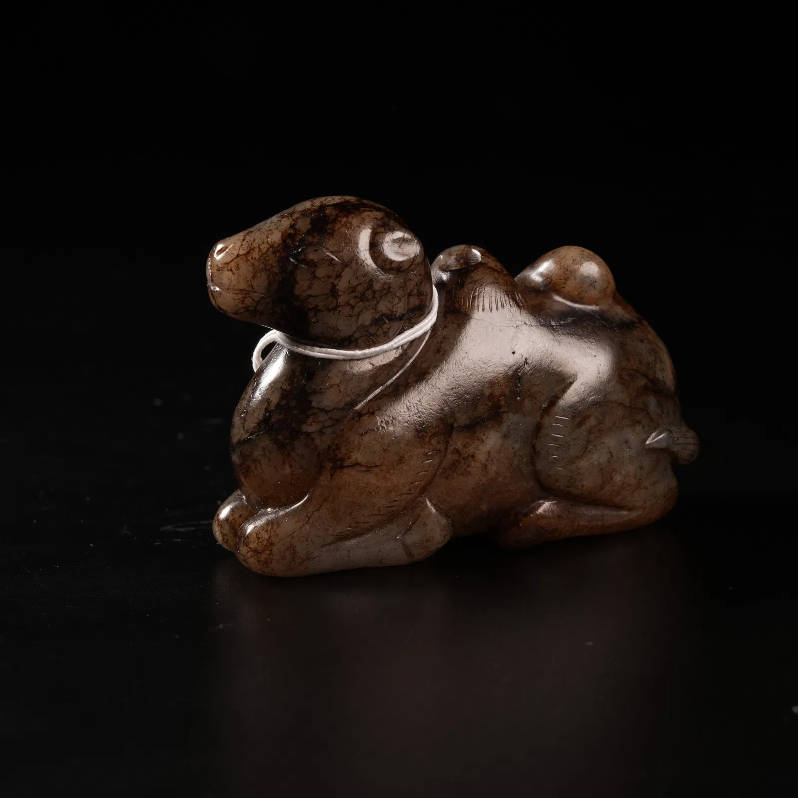 A ARCHAIC JADE CAMEL PENDANT