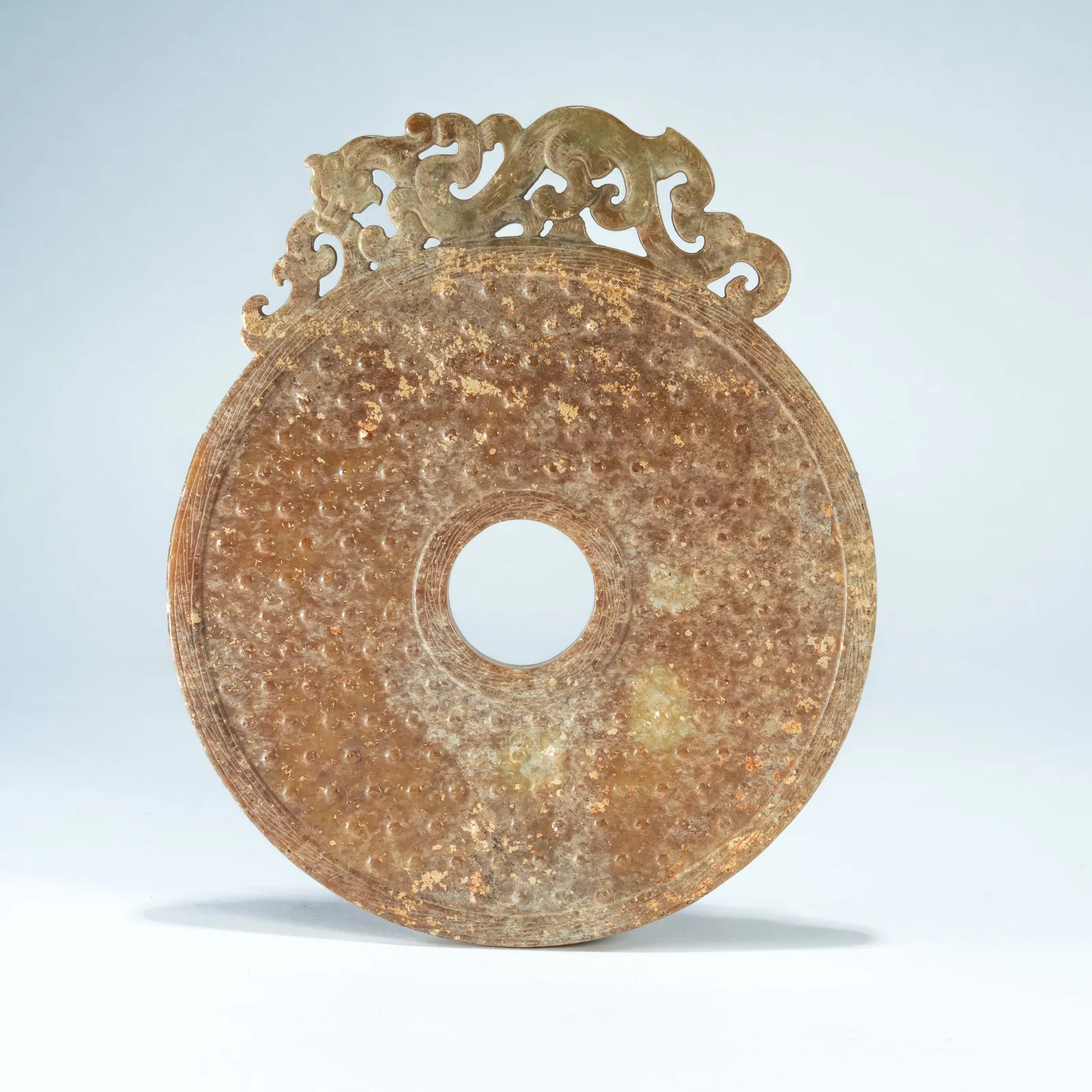 A ARCHAIC JADE CARVED BI DISC WITH BOSS PATTERN