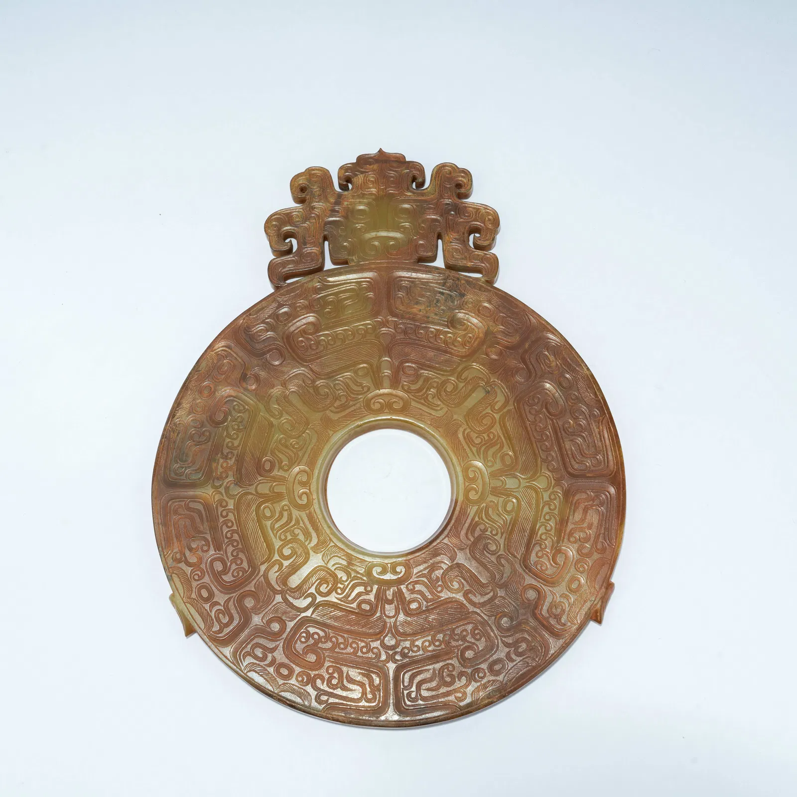 A ARCHAIC JADE CARVED BI DISC WITH RELIEF BEAST-MASK DESIGN