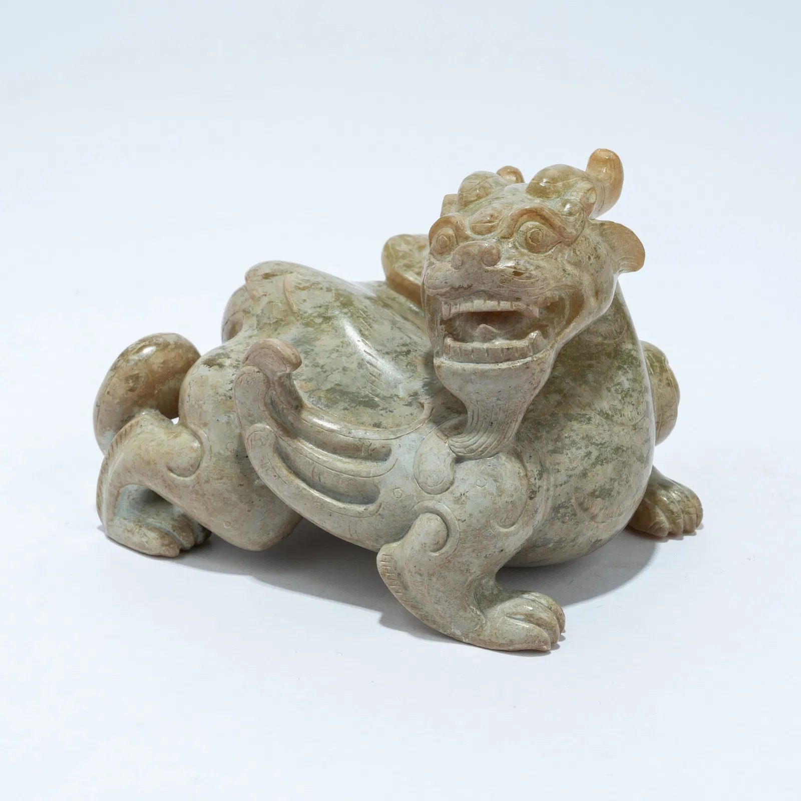 A ARCHAIC JADE CARVED BIXIE FIGURE