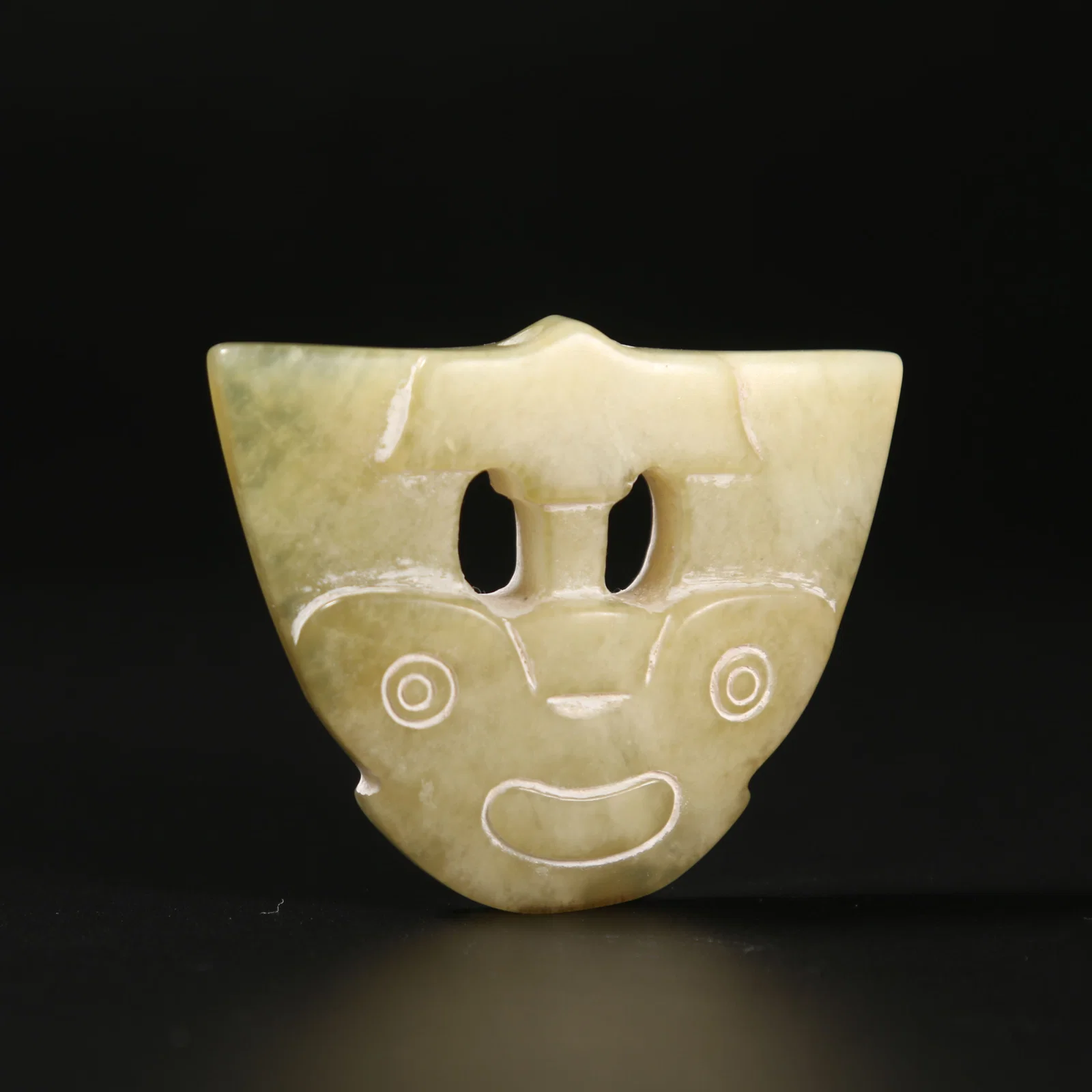 A ARCHAIC JADE MASK ORNAMENT