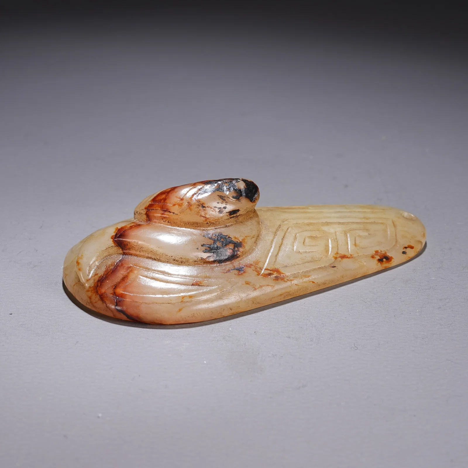 A ARCHAIC JADE PENDANT WITH SNAKE MOTIF