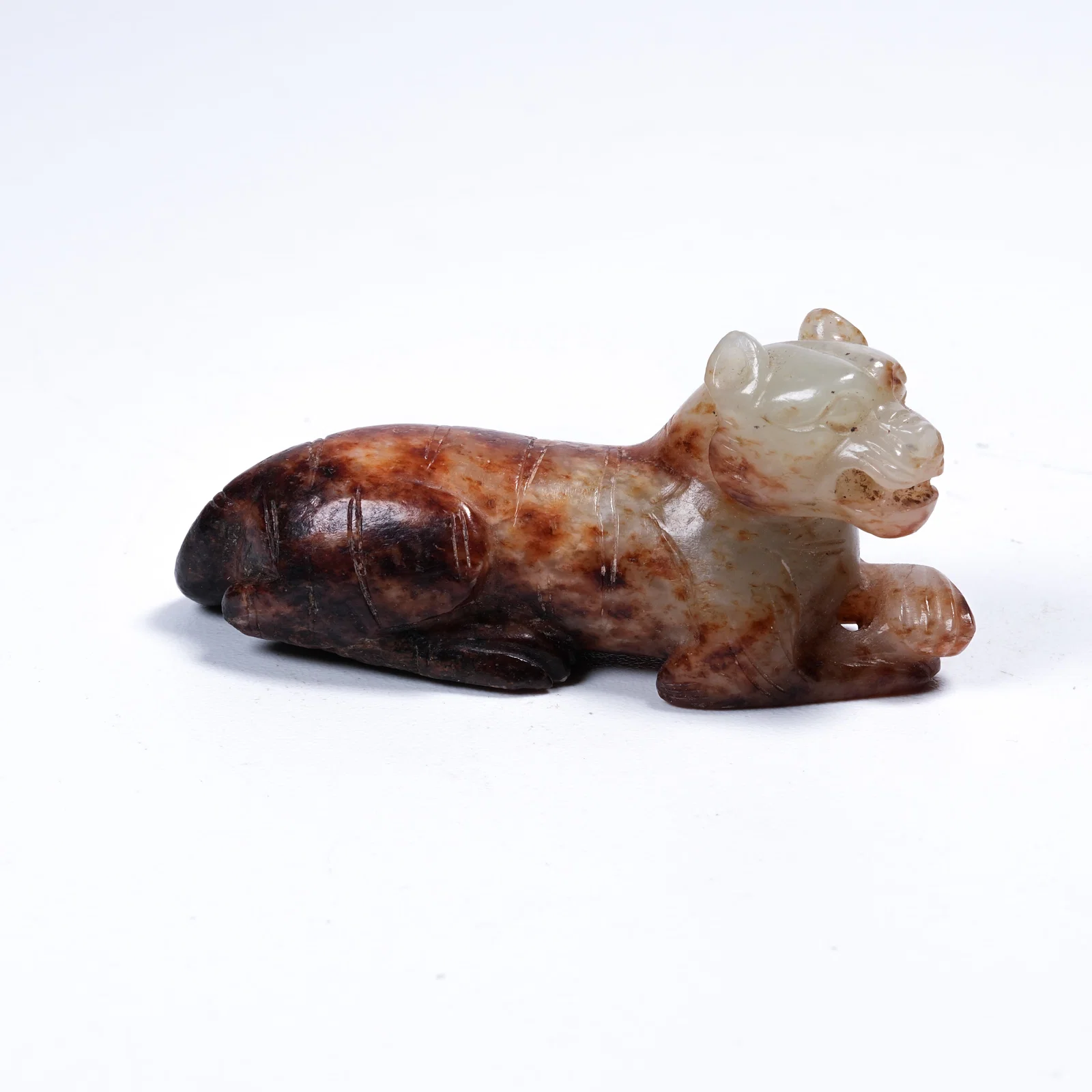 A ARCHAIC JADE TIGER ORNAMENT