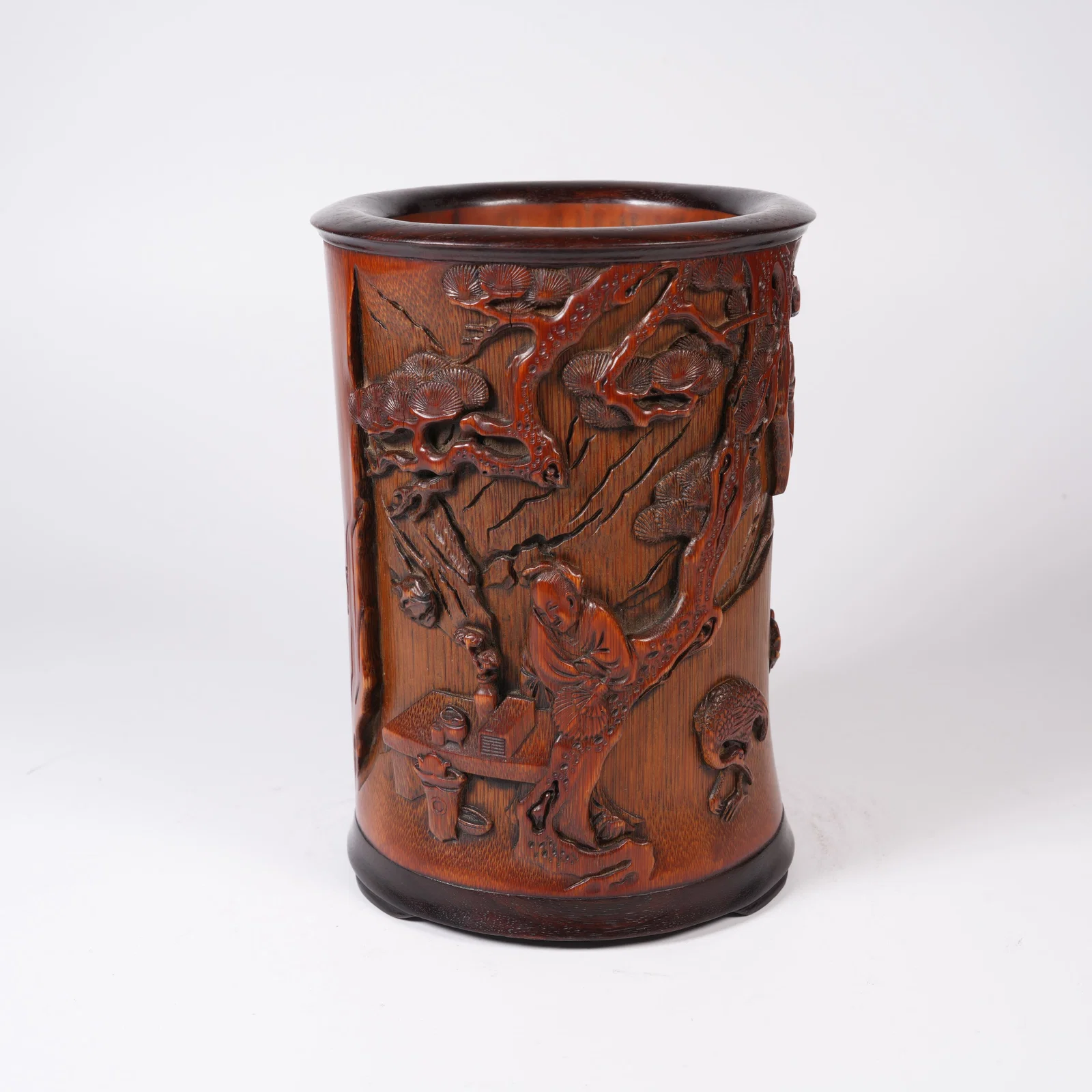 A BAMBOO-ROOT CARVED BRUSH POT WITH FIGURES UNDER PINE MOTIF