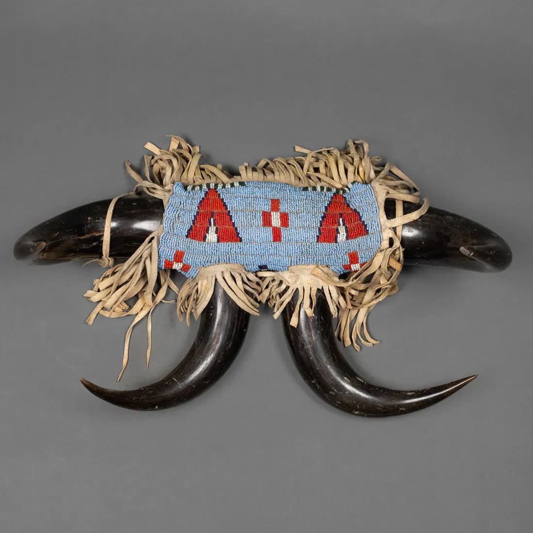A bead decorated buffalo horn coat rack