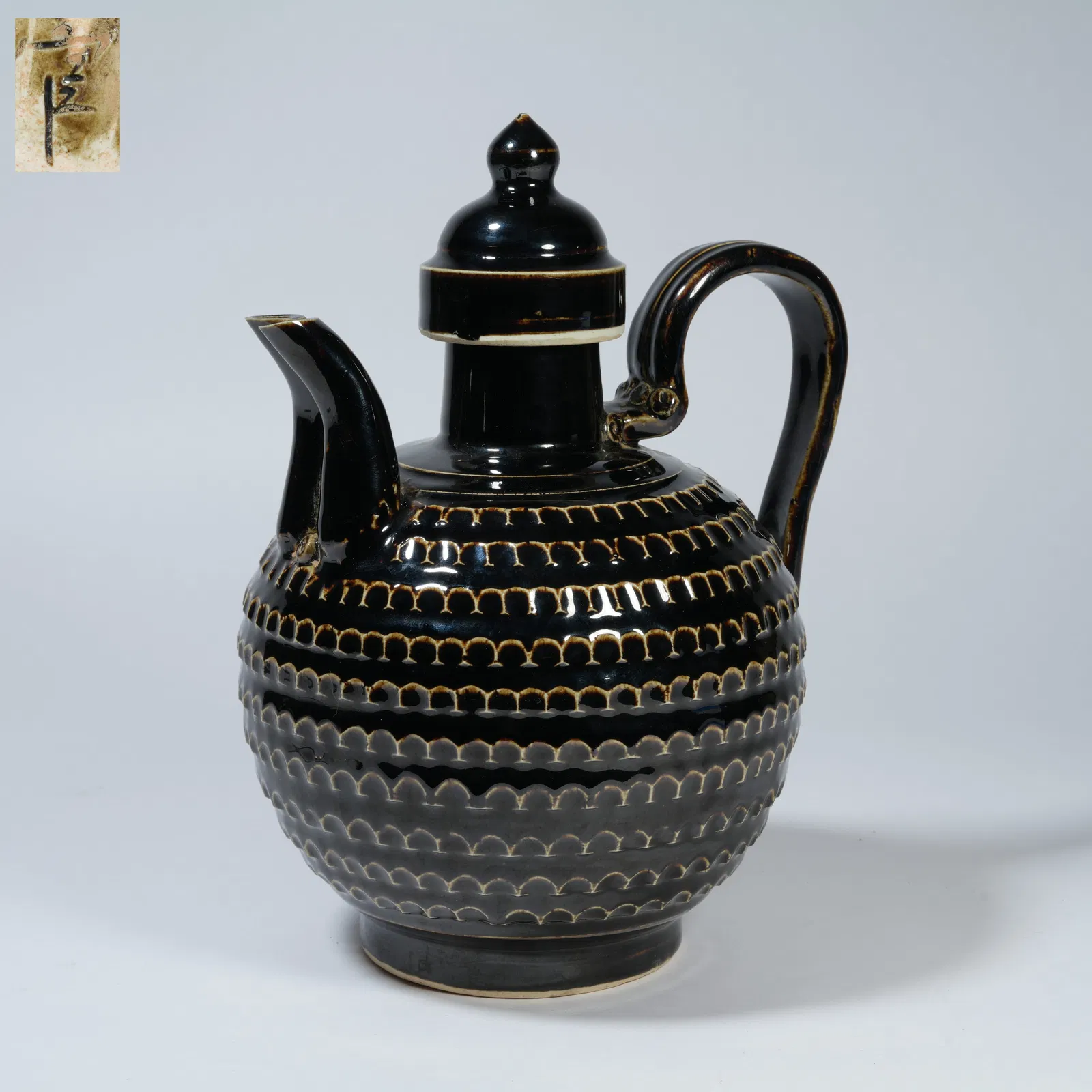 A BLACK DING WARE DOUBLE-HANDLED EWER