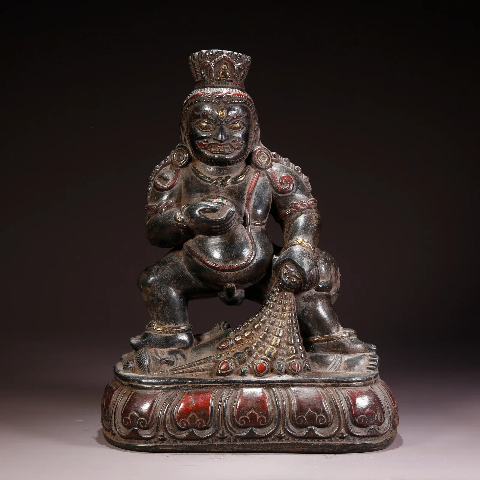 A BLACK STONE BLACK JAMBHALA FIGURE