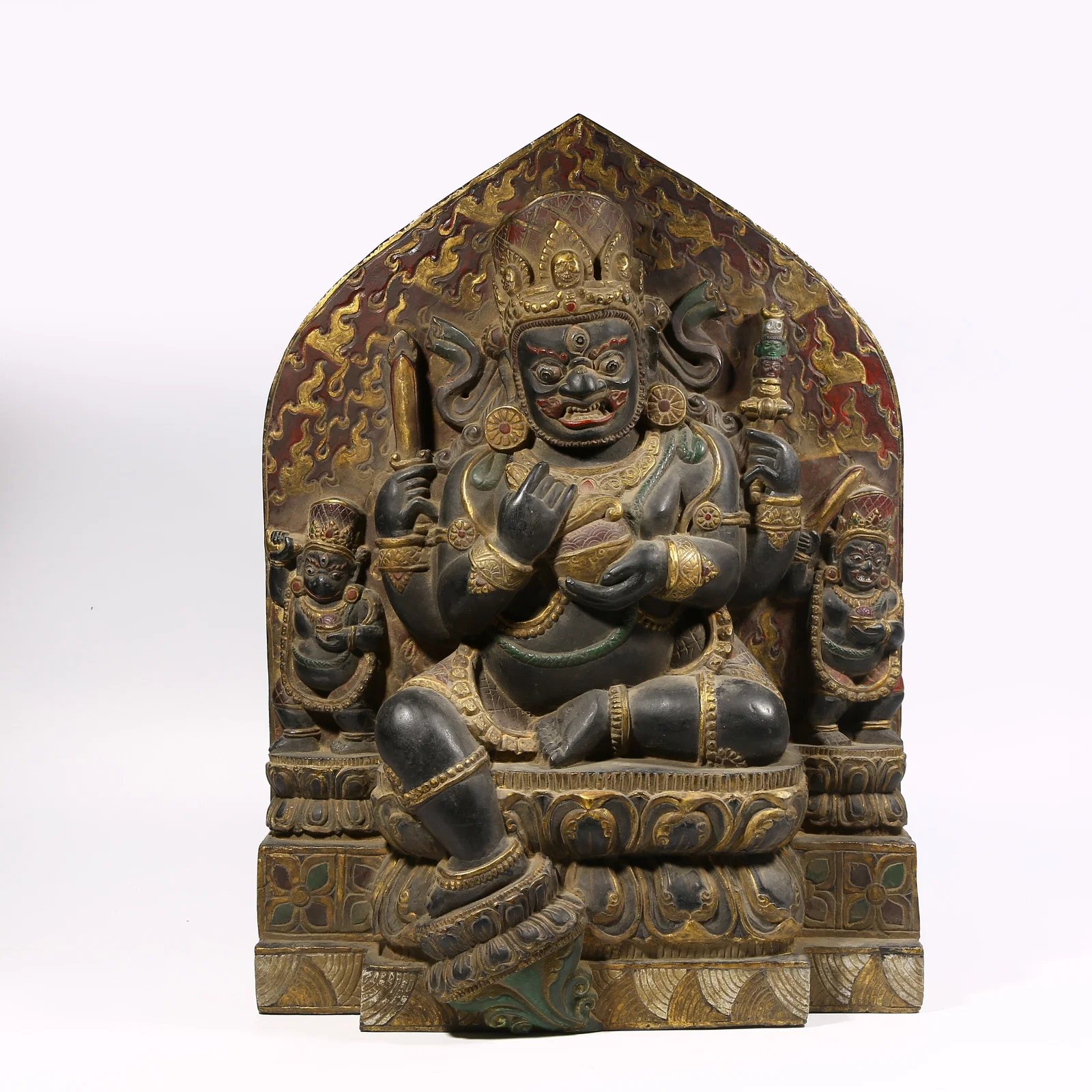 A BLACK STONE WITH COLOR PAINTED STATUE OF FOUR-ARMED MAHAKALA
