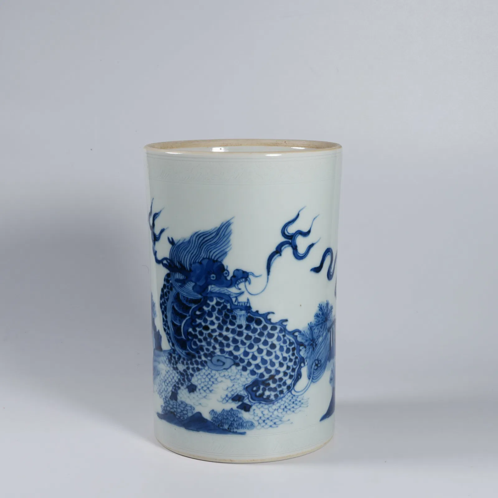 A BLUE-AND-WHITE AUSPICIOUS BEAST BRUSH POT