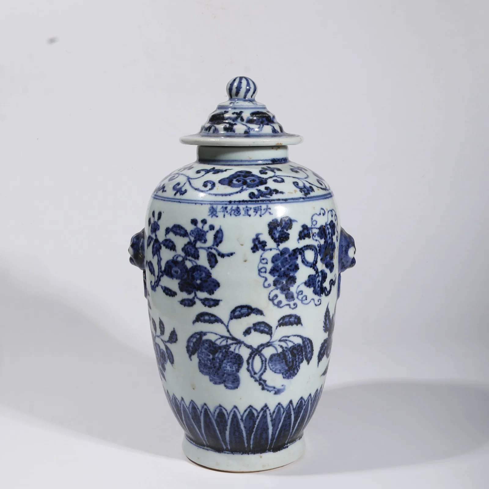 A BLUE-AND-WHITE BEAST-HANDLED JAR WITH FRUIT MOTIF