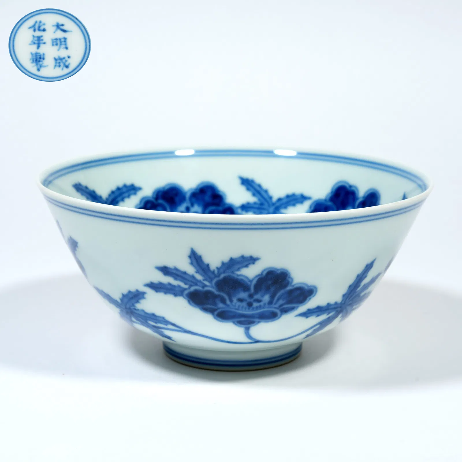 A BLUE-AND-WHITE BOWL WITH DAYLILY MOTIFS