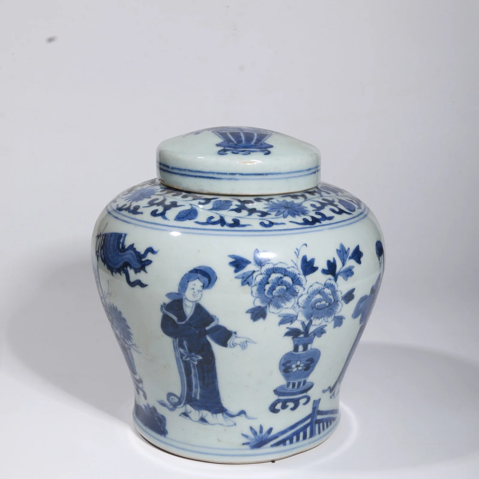 A BLUE-AND-WHITE COVERED JAR WITH FIGURES AND FLORAL MOTIF