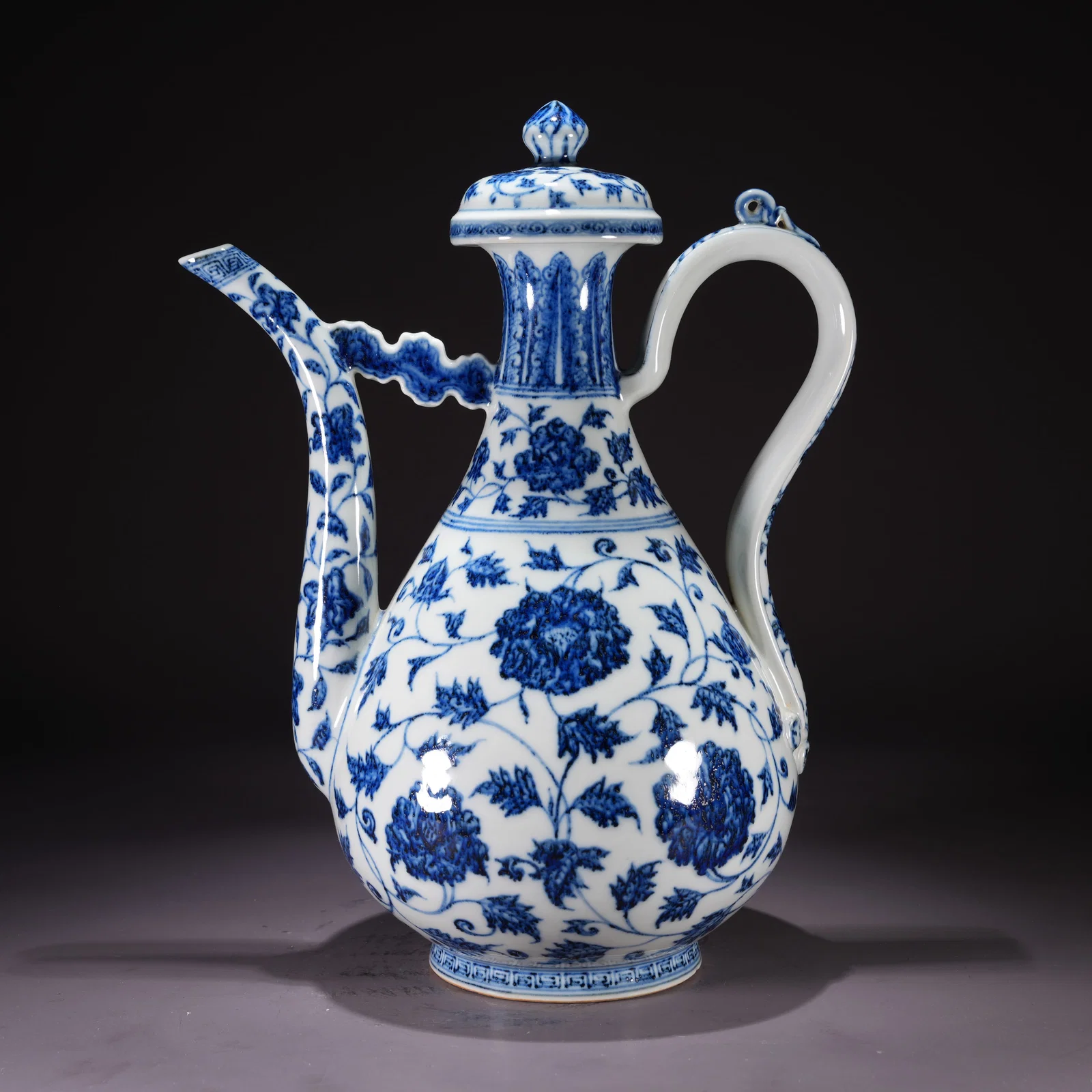A BLUE-AND-WHITE EWER WITH FLORAL SCROLL MOTIF