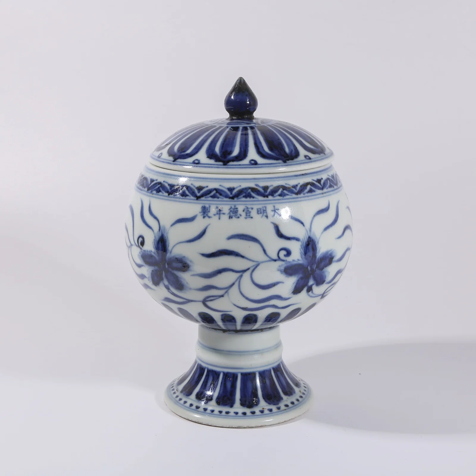 A BLUE-AND-WHITE FLORAL COVERED JAR