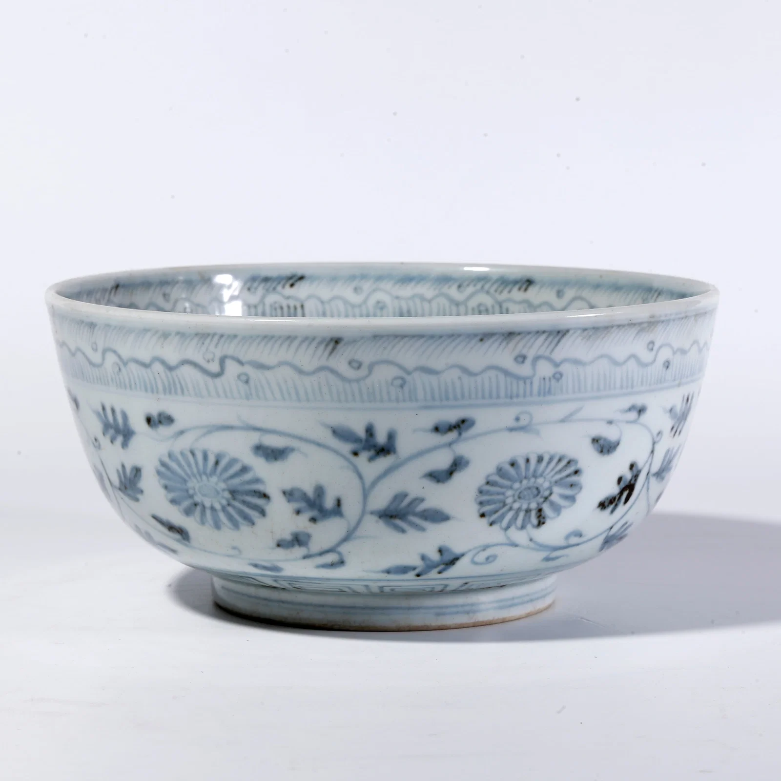 A BLUE-AND-WHITE FLORAL SCROLL BOWL