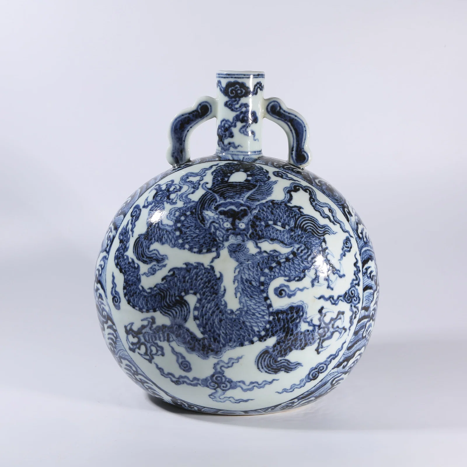 A BLUE-AND-WHITE MOON FLASK WITH DRAGON-AND-WAVES MOTIF AND RIBBON-SHAPED HANDLES