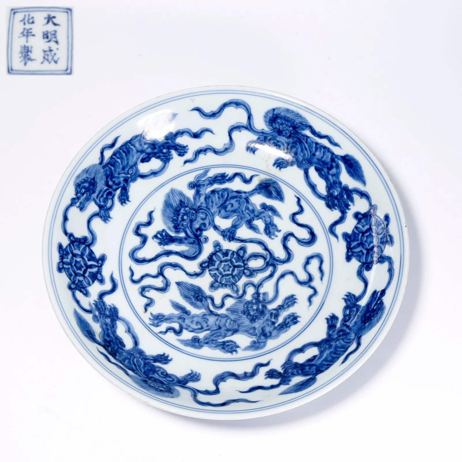 A BLUE-AND-WHITE PLATE WITH LION PLAYING WITH BALL PATTERN