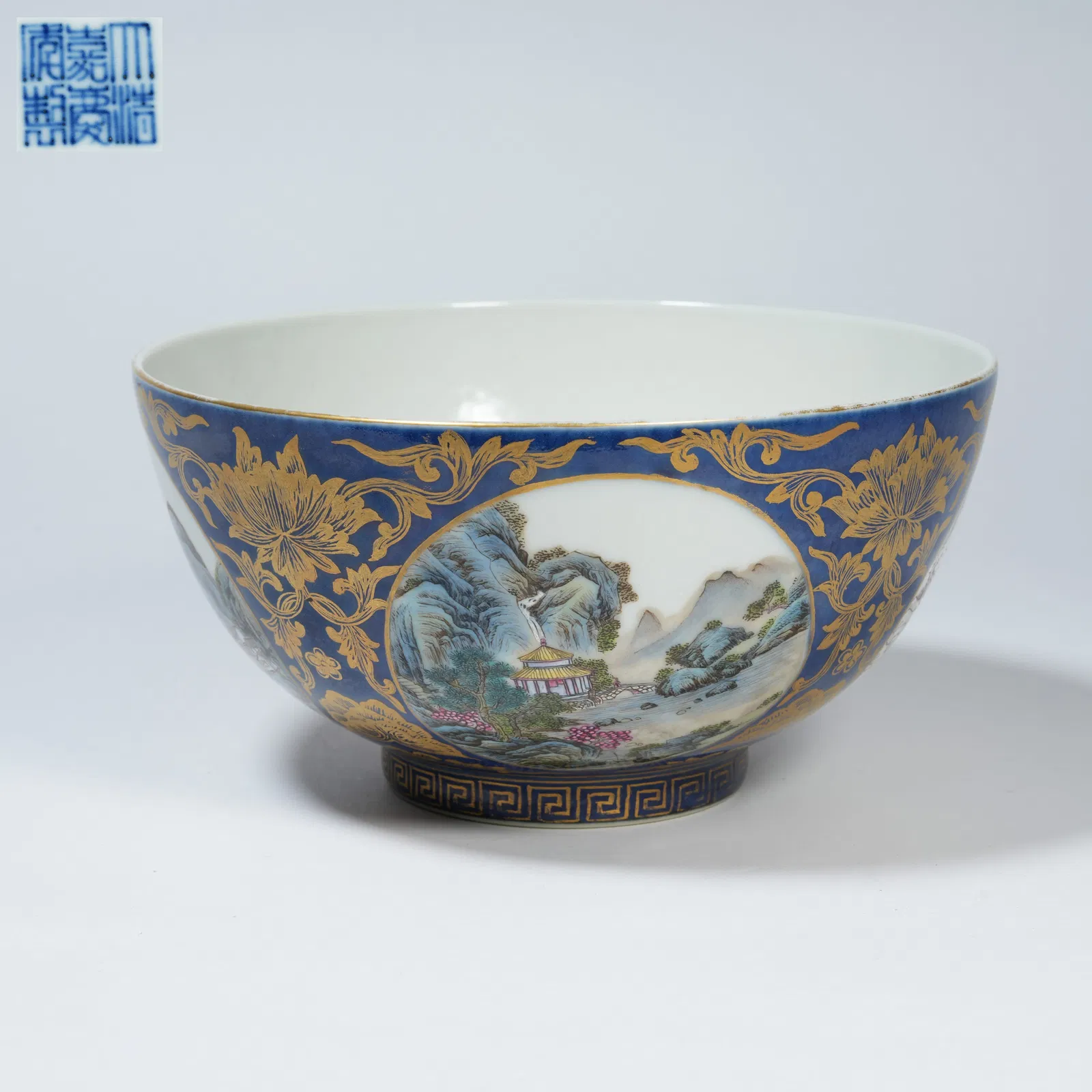 A BLUE-GROUND FAMILLE-ROSE BOWL WITH PANELLED FOUR-SEASON LANDSCAPE DECORATION, GILT-DECORATED