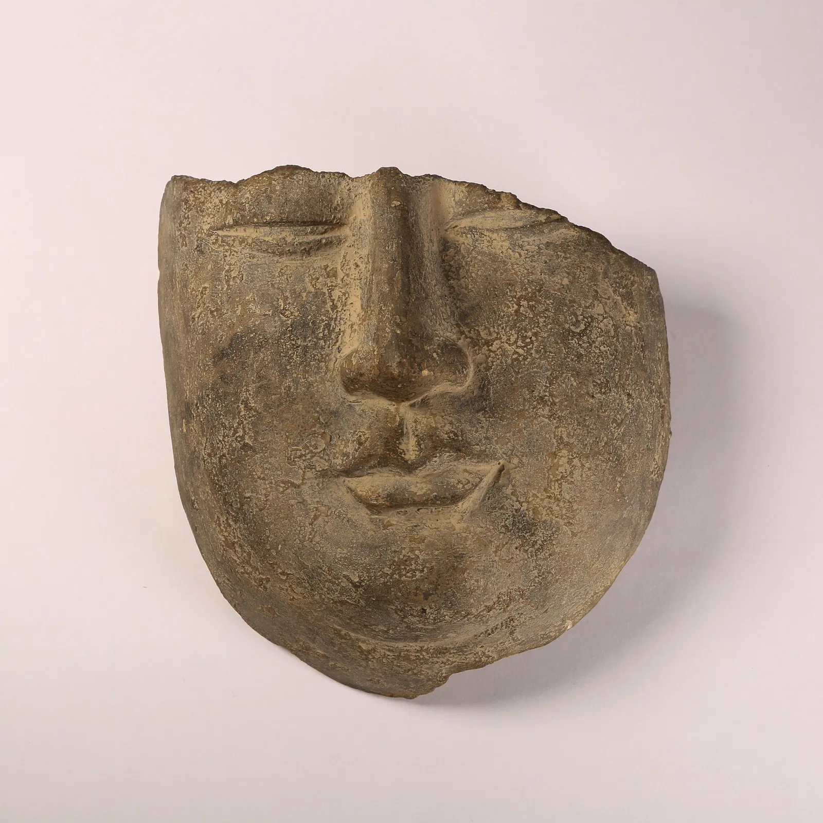 A BLUESTONE BUDDHIST FACE