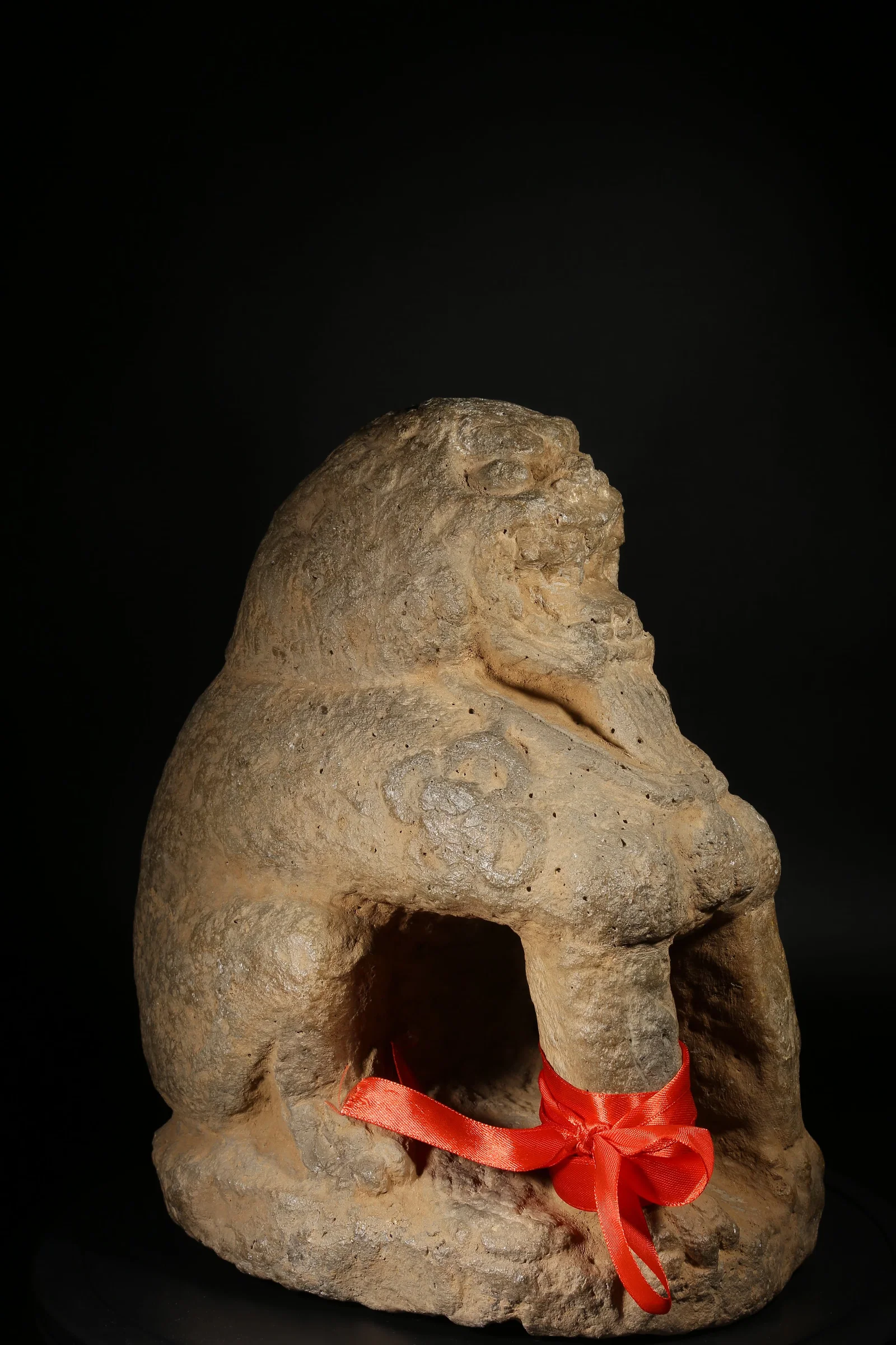 A BLUESTONE SEATED LION