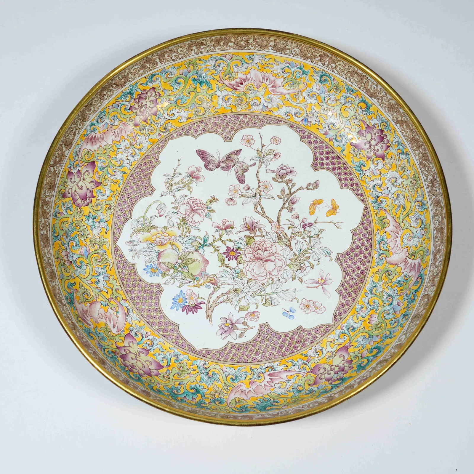 A BRONZE-BASED PAINTED-ENAMEL DISH WITH FLORAL MOTIFS