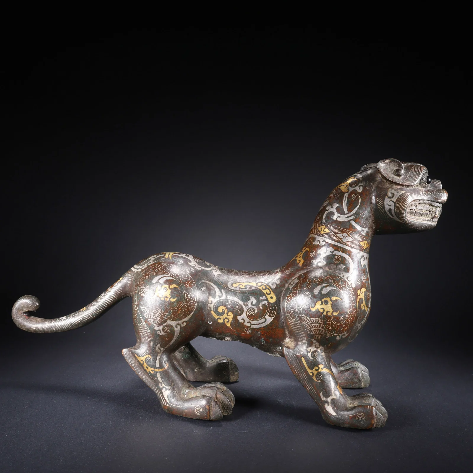 A BRONZE BEAST INLAID WITH GOLD AND SILVER