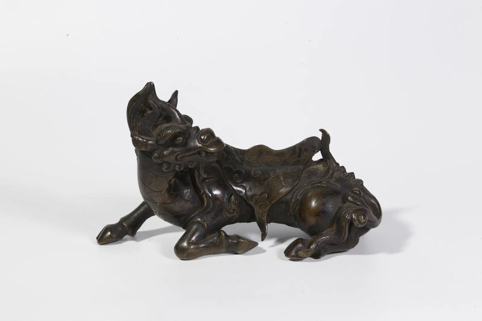 A BRONZE BEAST-SHAPED ORNAMENT