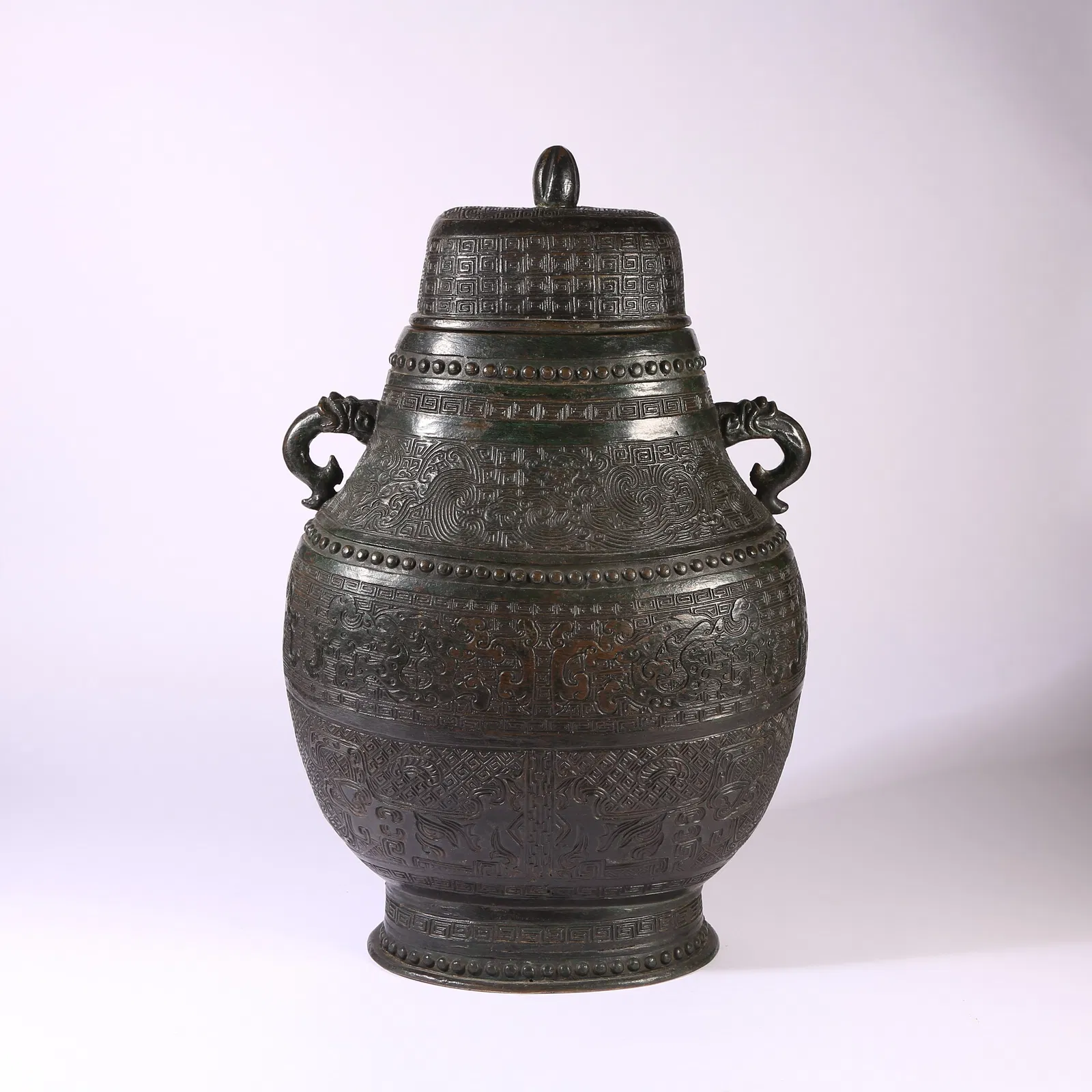 A BRONZE COVERED VASE WITH BEAST-HEAD HANDLES AND AUSPICIOUS BEAST MOTIFS