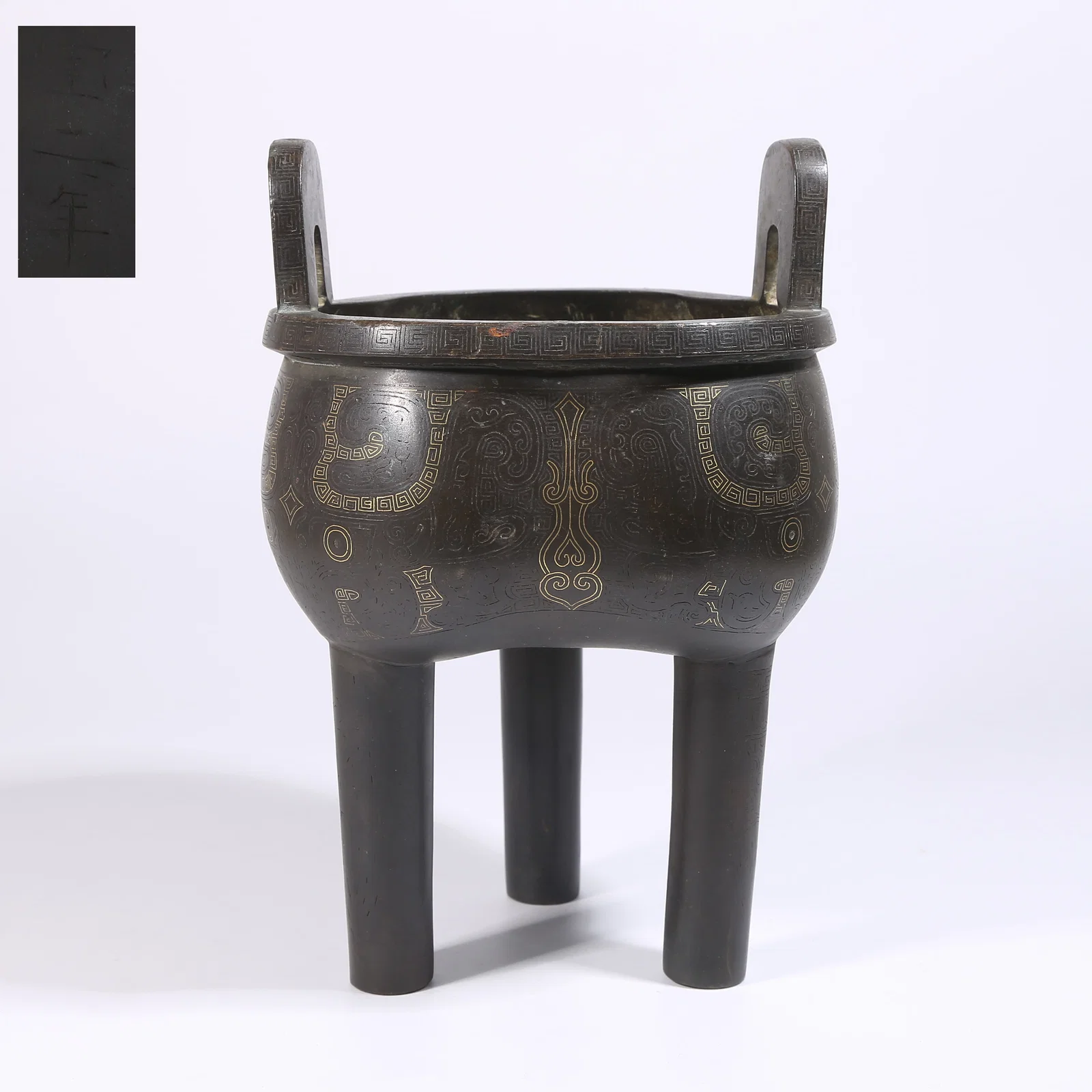 A BRONZE DING-STYLE CENSER WITH TAOTIE MASK DESIGN INLAID WITH GOLD AND SILVER
