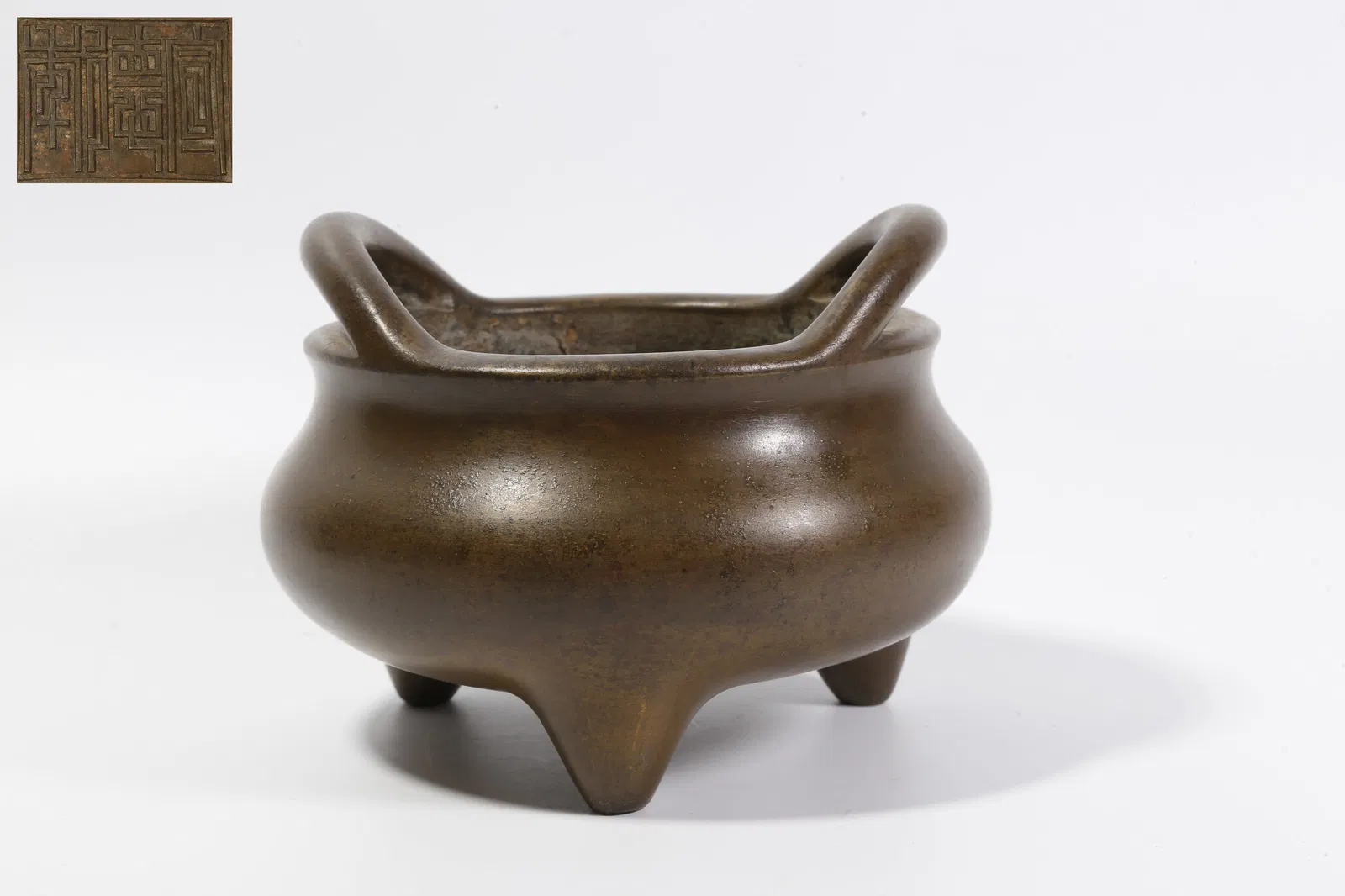 A BRONZE DOUBLE-BRIDGE-HANDLED INCENSE BURNER