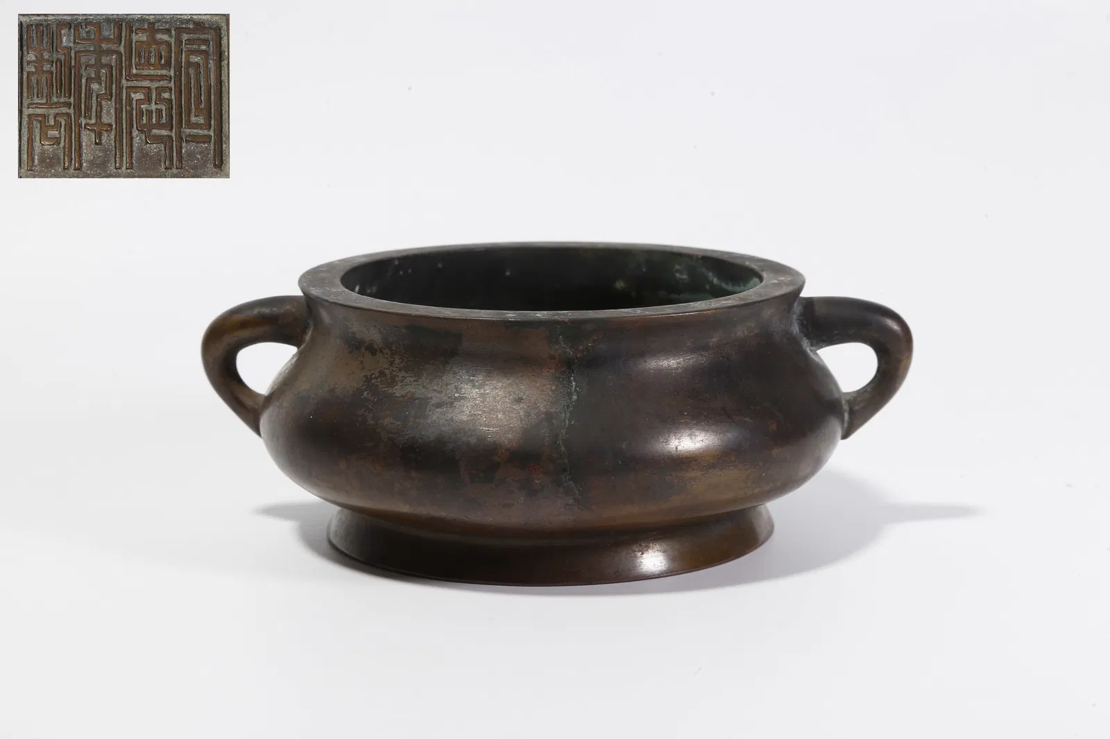 A BRONZE DOUBLE-HANDLED CENSER