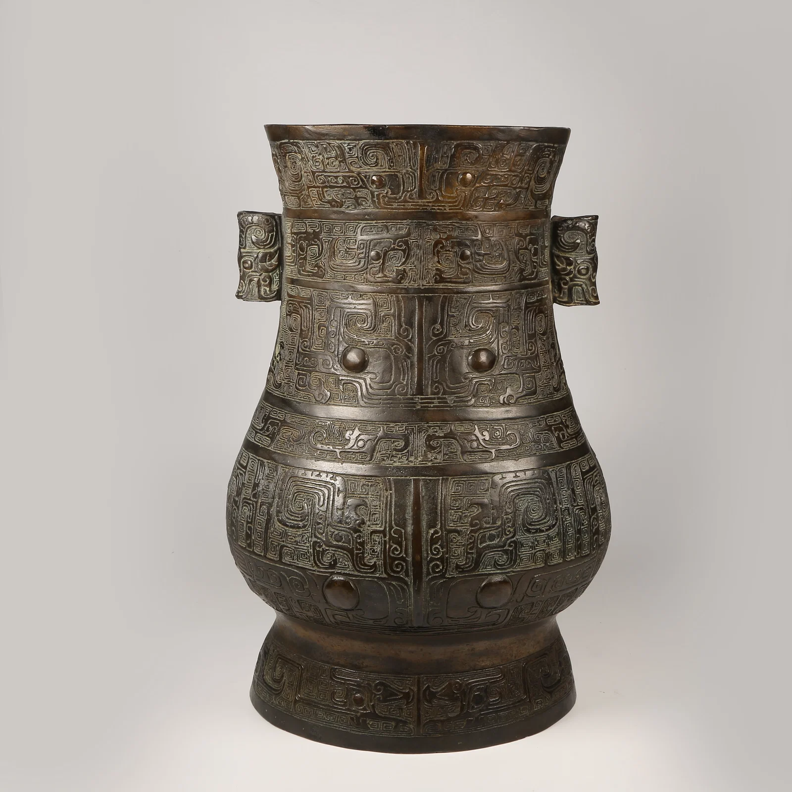 A BRONZE EWER WITH KUI-DRAGON MOTIFS AND ANIMAL-FORM HANDLES