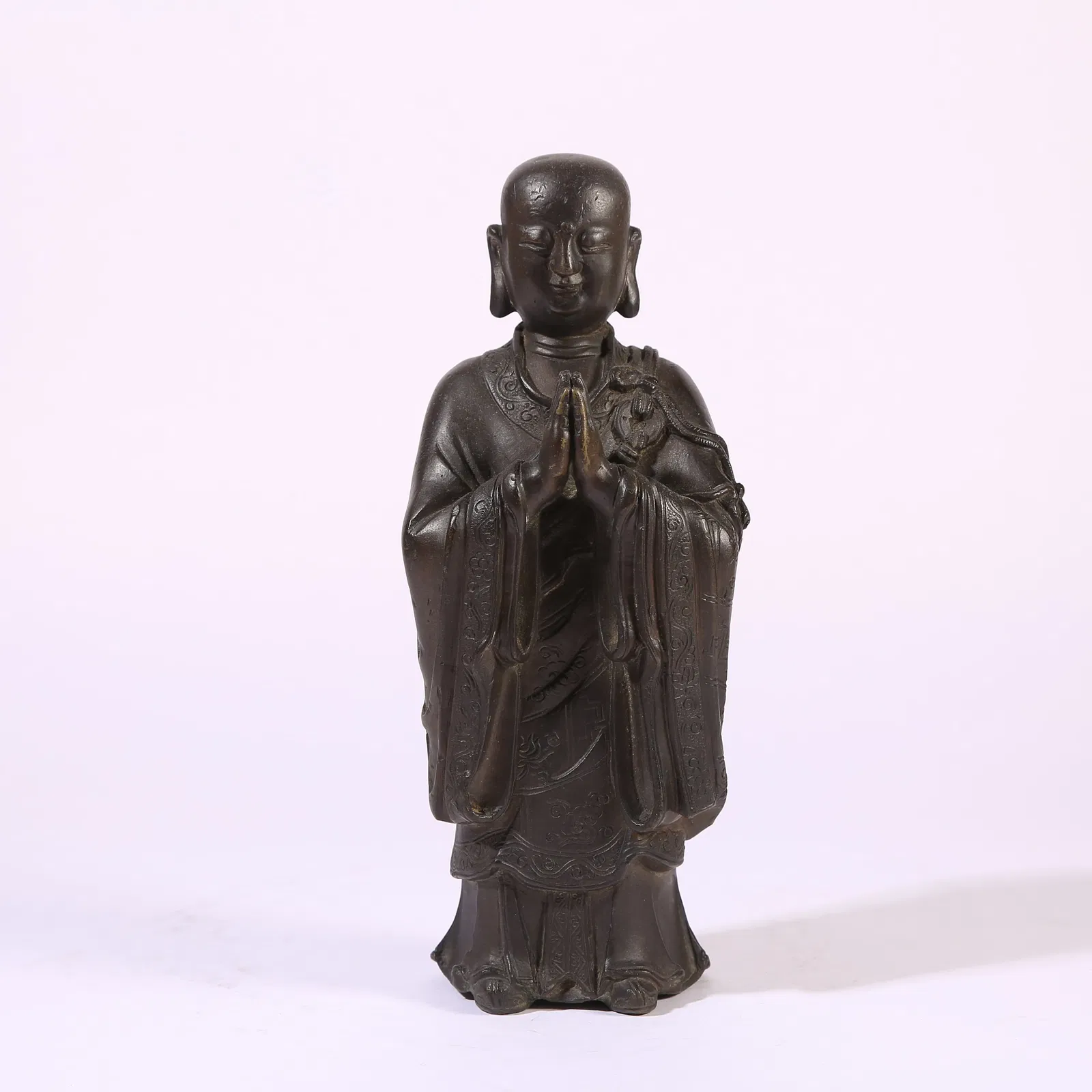 A BRONZE FIGURE OF ANANDA