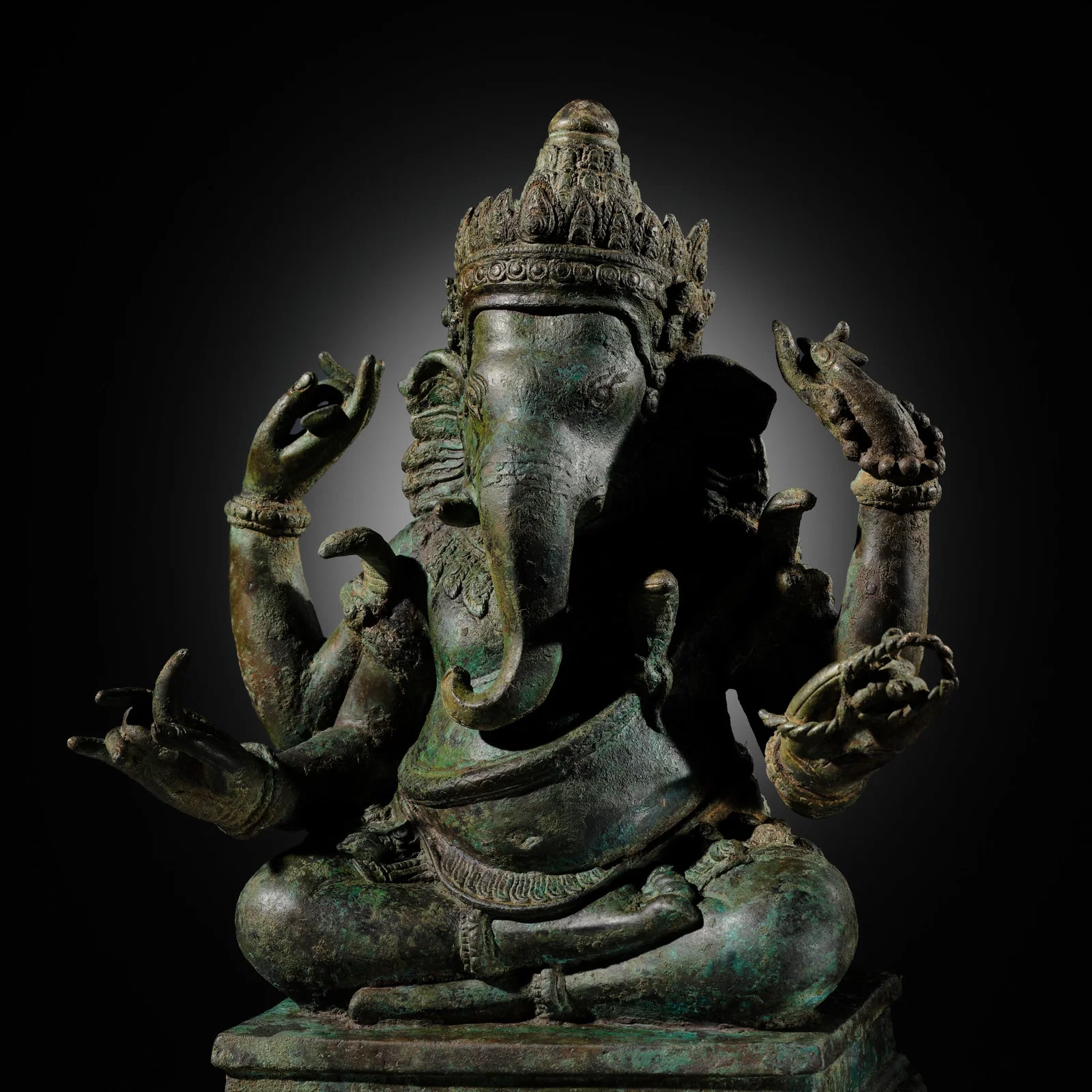 A BRONZE FIGURE OF GANESHA, ANGKOR PERIOD, KHMER EMPIRE, 12TH-13TH CENTURY