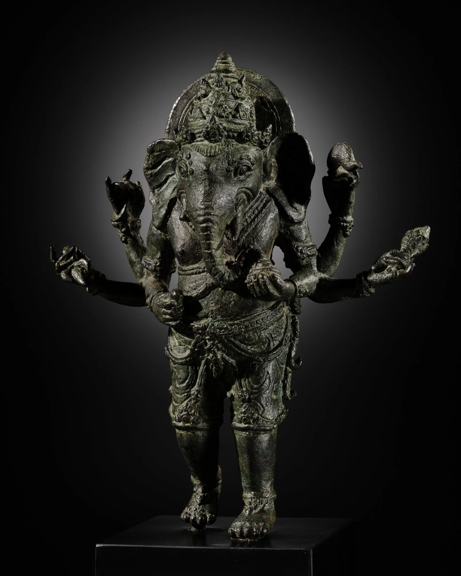 A BRONZE FIGURE OF GANESHA, SOUTHEAST ASIA, CHOLA EMPIRE SPHERE, 12TH-13TH CENTURY