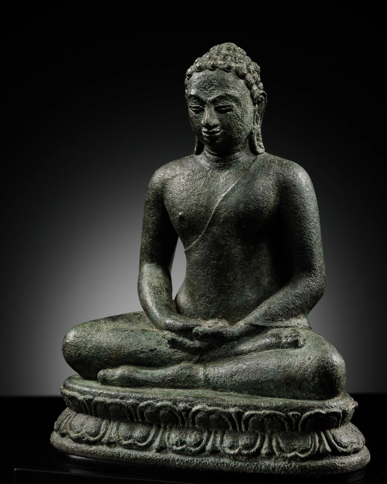 A BRONZE FIGURE OF THE SEATED BUDDHA, SUMATRA, SRIVIJAYA PERIOD, 8TH-9TH CENTURY