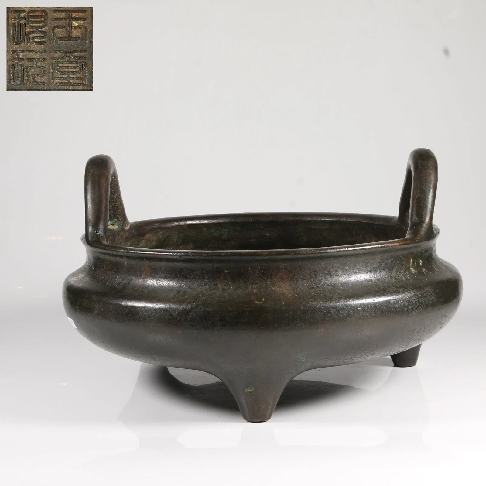 A BRONZE FURNACE WITH HIGH-EARED DESIGN